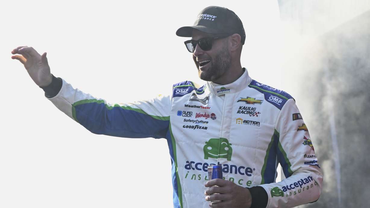 FILE - Shane van Gisbergen waves to fans prior to a NASCAR Cup Series auto race at Darlington Raceway, Sept. 1, 2024, in Darlington, S.C.
