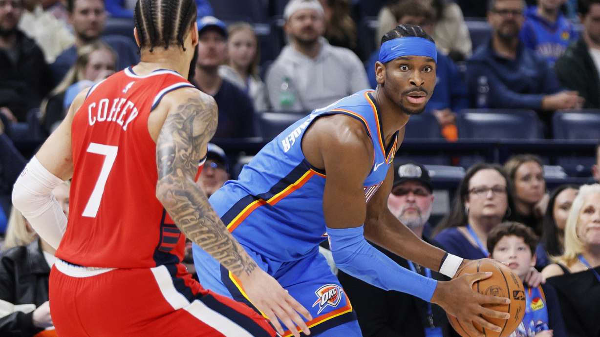 Oklahoma City Thunder guard Shai Gilgeous-Alexander, right, looks for an outlet as Los Angeles Clippers guard Amir Coffey (7) defends during the first half of an NBA basketball game Thursday, Jan. 2, 2025, in Oklahoma City.
