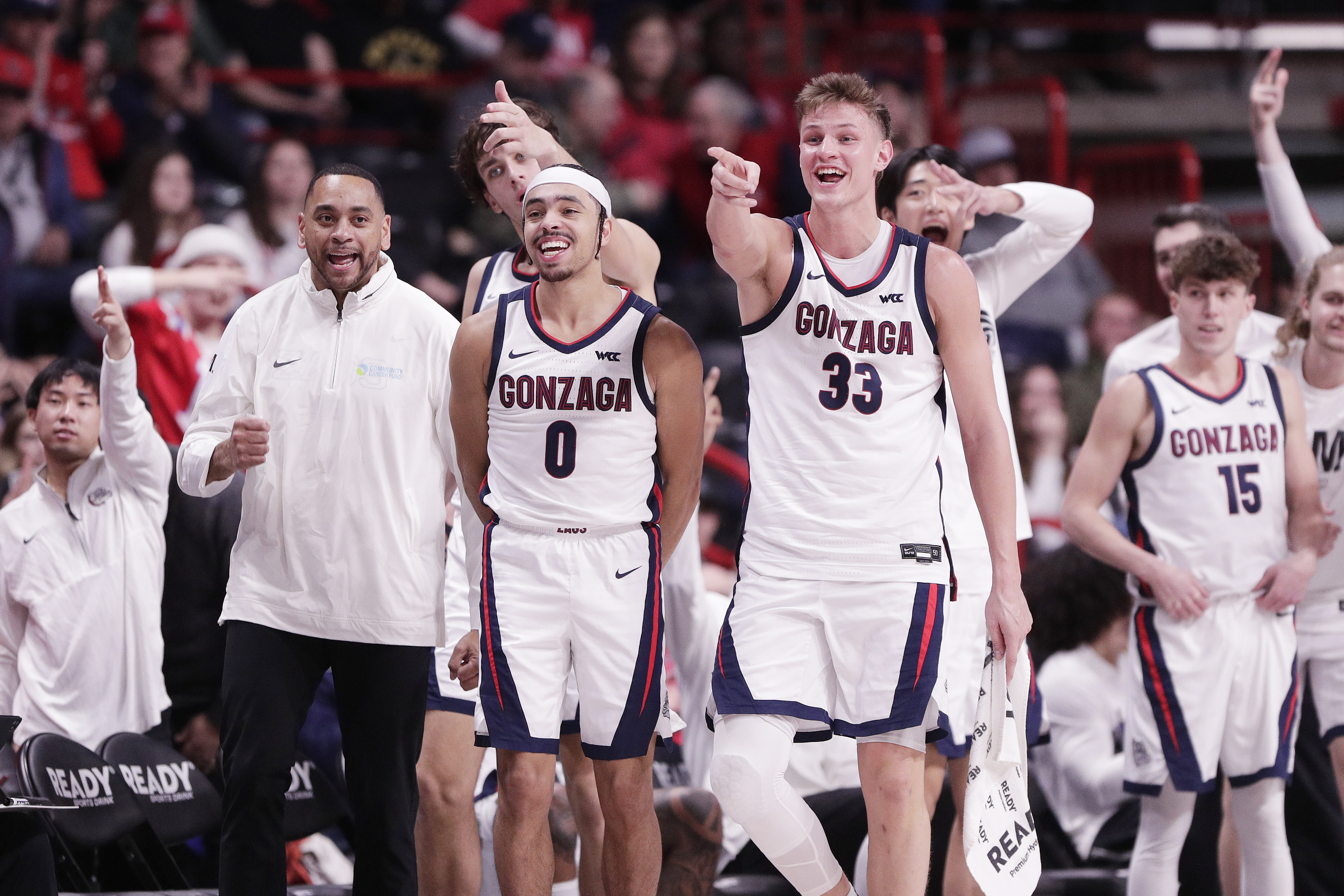 The Gonzaga bench celebrates a 3-point basket by Emmanuel Innocenti during the second half of an NCAA college basketball game against Portland, Thursday, Jan. 2, 2025, in Spokane, Wash.