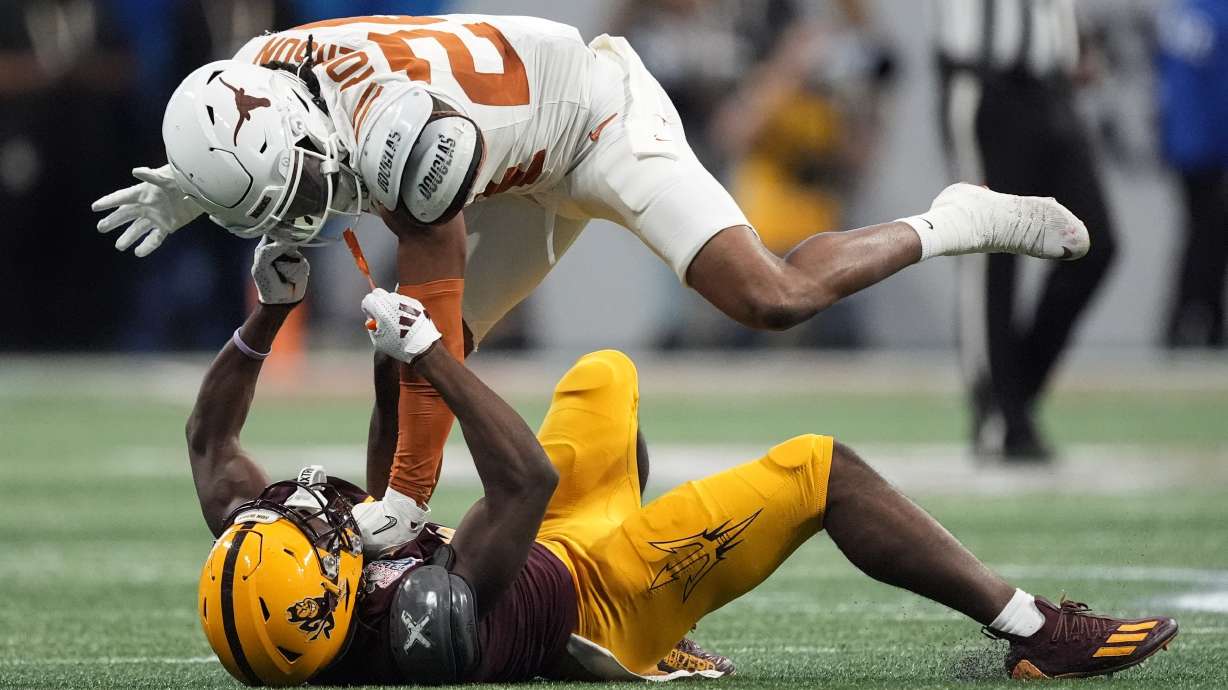 Arizona State wide receiver Melquan Stovall (5) and Texas defensive back Warren Roberson (24) collide during the first half in the quarterfinals of a College Football Playoff, Wednesday, Jan. 1, 2025, in Atlanta.