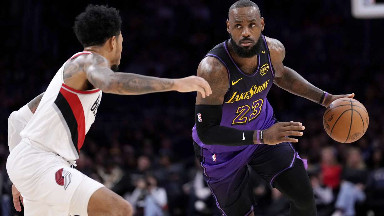 Los Angeles Lakers forward LeBron James, right, drives by Portland Trail Blazers guard Anfernee Simons during the first half of an NBA basketball game, Thursday, Jan. 2, 2025, in Los Angeles.