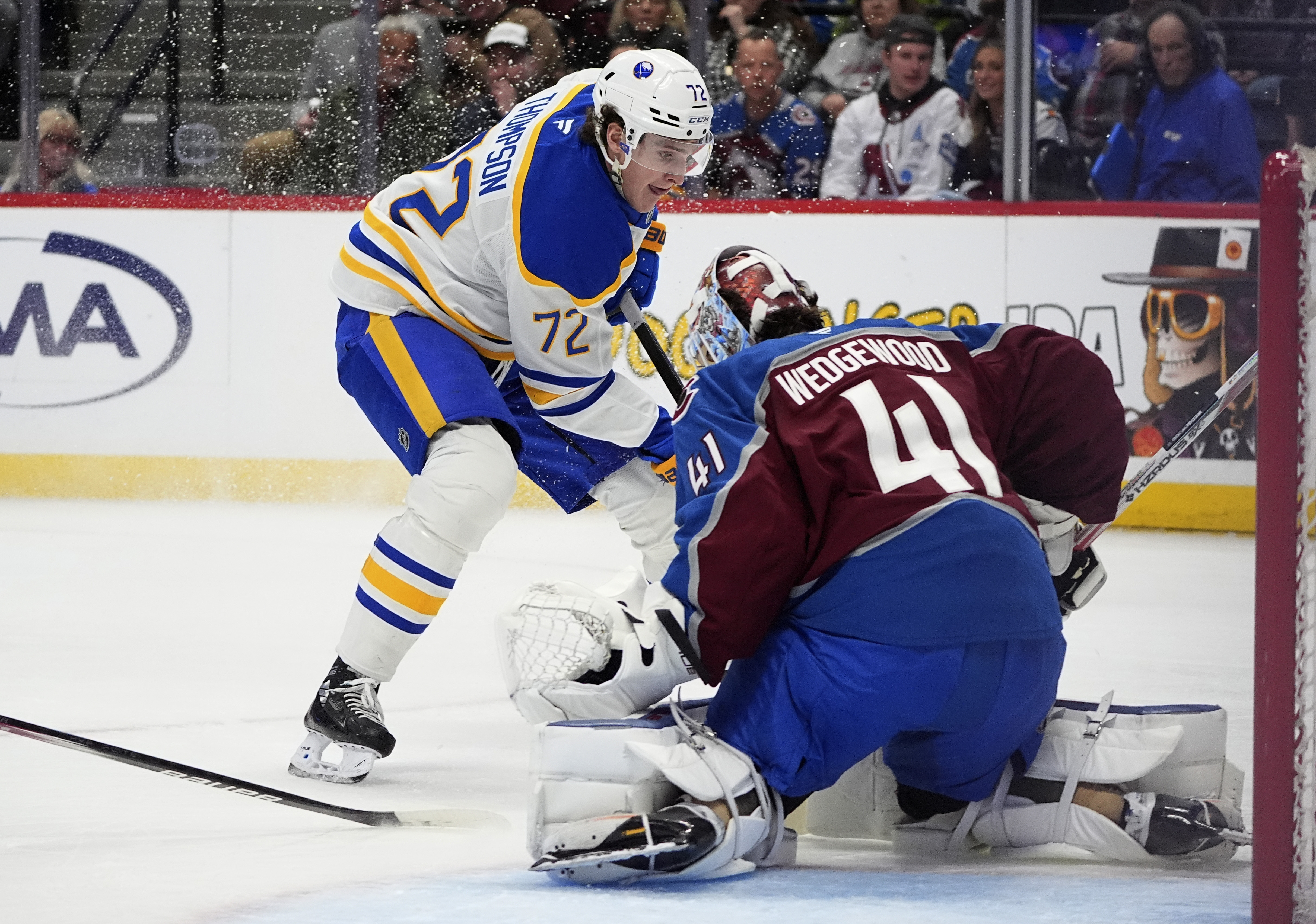 Buffalo Sabres center Tage Thompson, back, puts a shot on Colorado Avalanche goaltender Scott Wedgewood in the second period of an NHL hockey game Thursday, Jan. 2, 2025, in Denver.