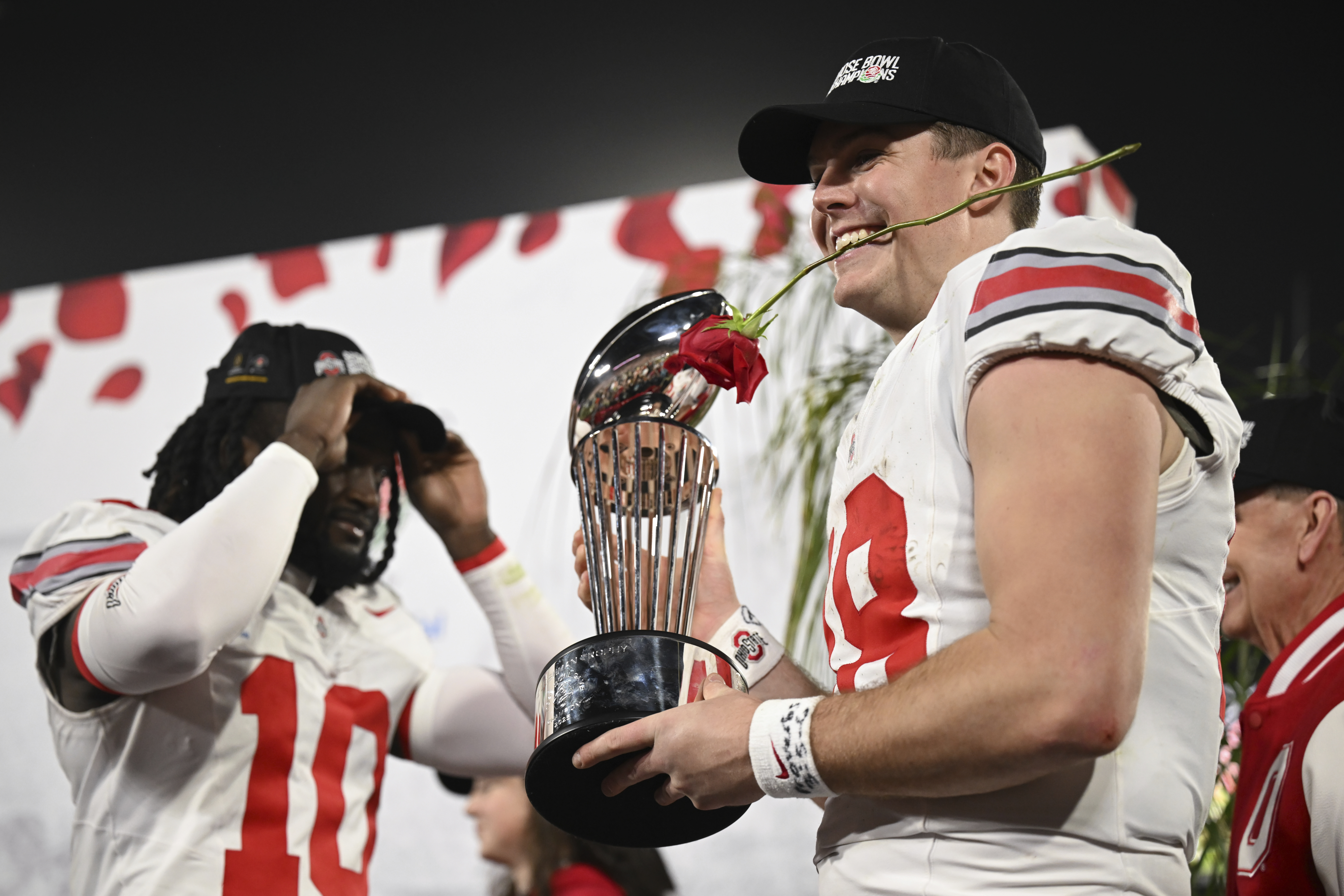 Ohio State quarterback Will Howard (18) celebrates with the trophy after the quarterfinals of the Rose Bowl College Football Playoff against Oregon, Wednesday, Jan. 1, 2025, in Pasadena, Calif.