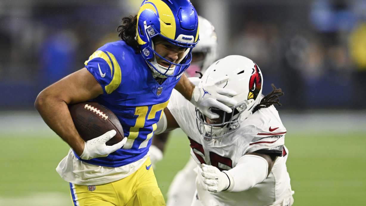 Los Angeles Rams wide receiver Puka Nacua (17) stiff-arms Arizona Cardinals defensive tackle Dante Stills (55) after a reception during the second half of an NFL football game Saturday, Dec. 28, 2024, in Inglewood, Calif.