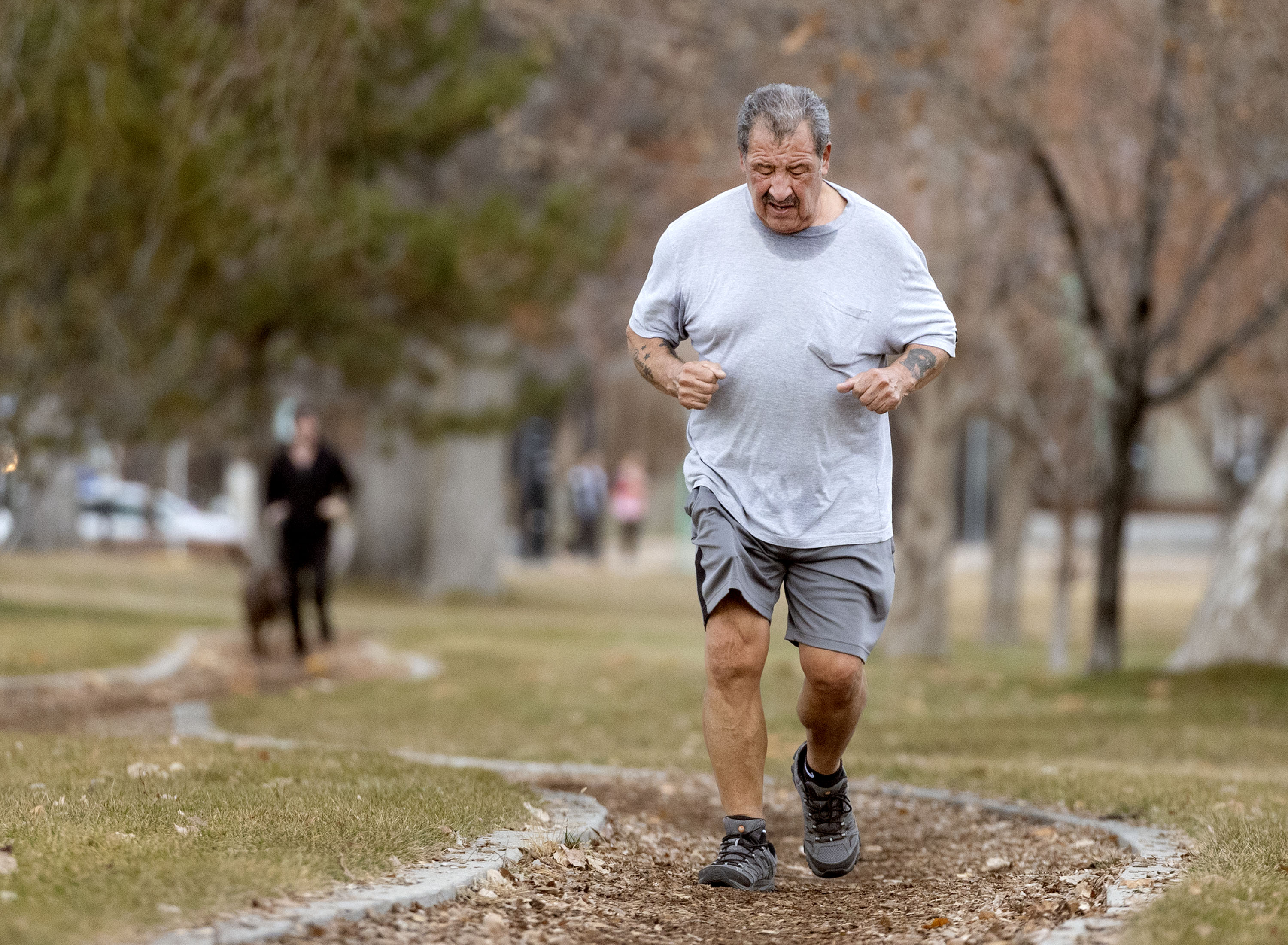 Juan Reyes works up a sweat while jogging in Liberty Park in Salt Lake City on Friday, as temperatures reached the upper 50s. Another winter storm is on the way for Saturday morning into Sunday, lowing temperatures and potentially bringing in valley snow.