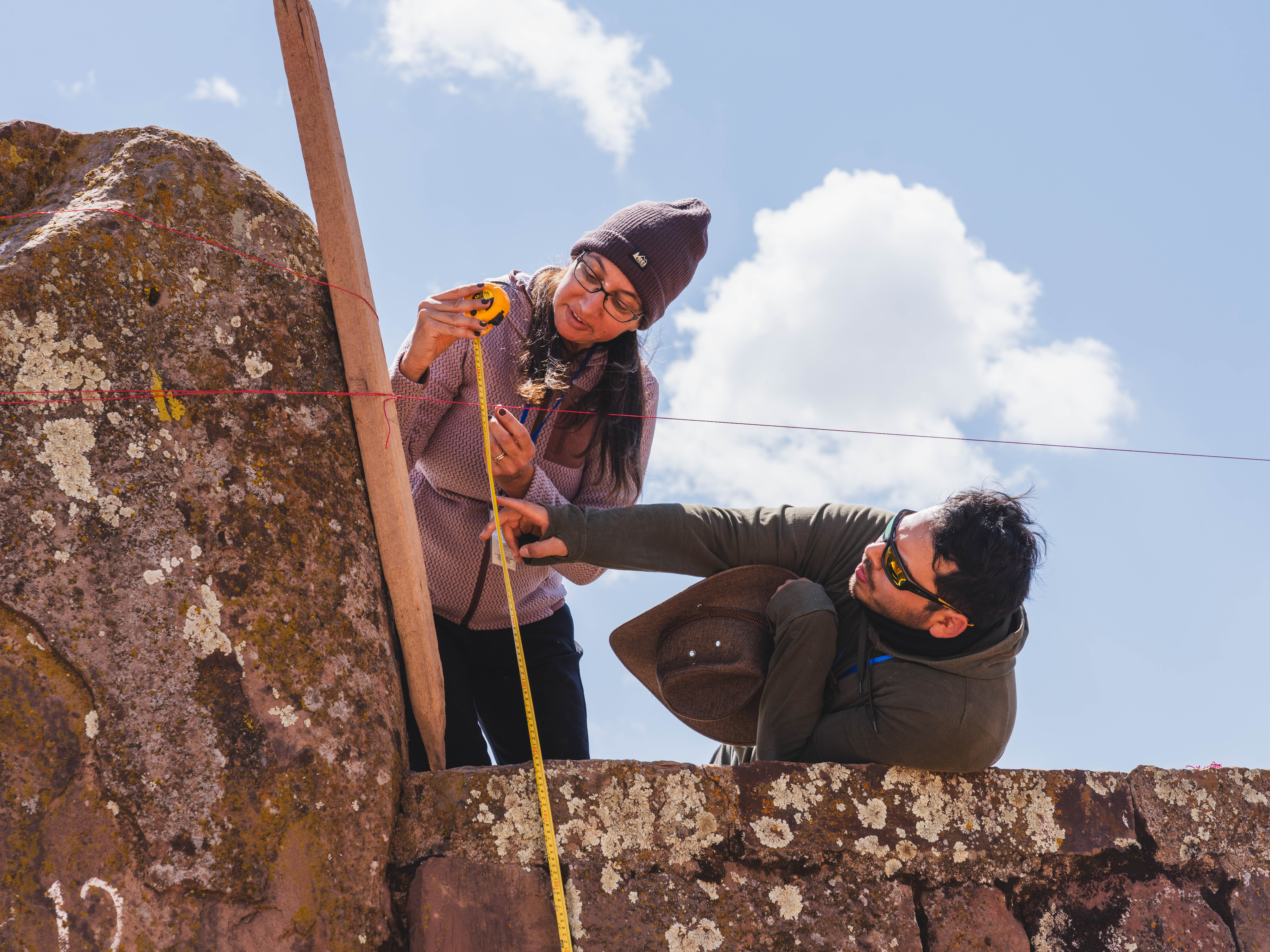 A UVU professor, left, works with UVU students during their trip to Bolivia. A group from UVU worked with a local community and Bolivian university students to assist in preserving a UNESCO site.