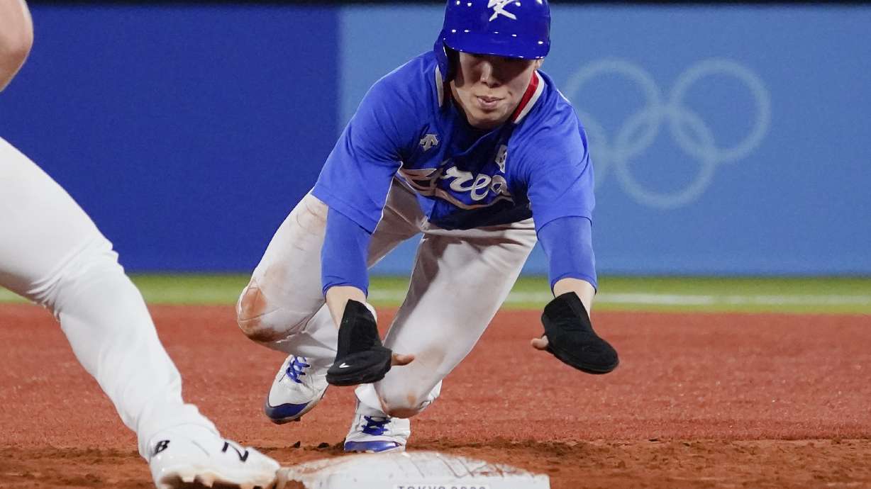 FILE - South Korea's Hyeseong Kim beats a tag by United States' Triston Casas in a pickoff-attempt at first base during the fifth inning of a baseball game at the 2020 Summer Olympics, July 31, 2021, in Yokohama, Japan.