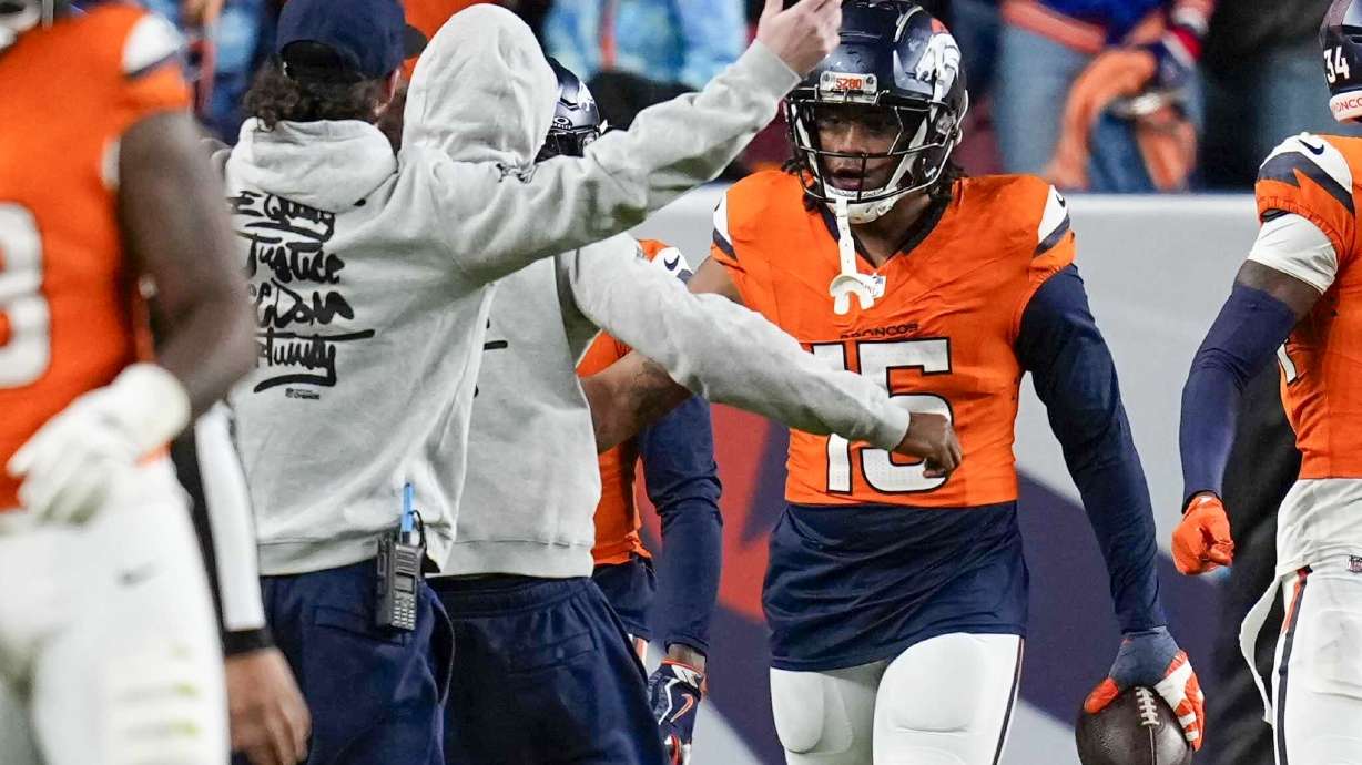 Denver Broncos' Nik Bonitto celebrates after returning an interception for a touchdown during the second half of an NFL football game against the Indianapolis Colts Sunday, Dec. 15, 2024, in Denver.