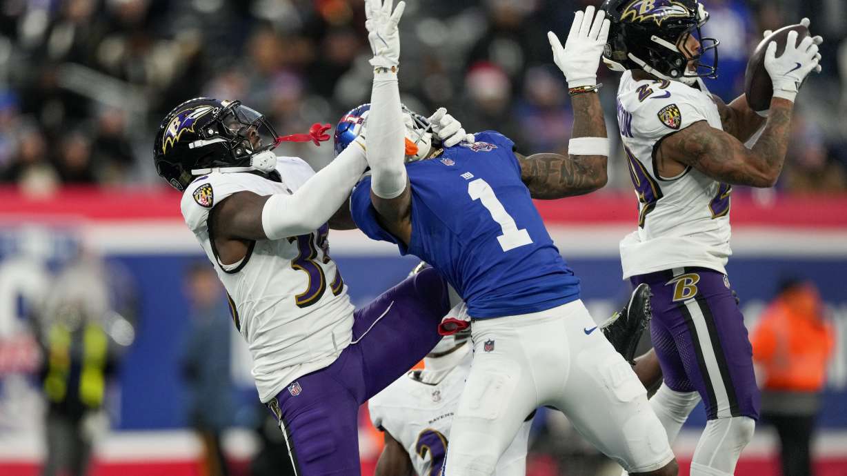 Baltimore Ravens safety Ar'Darius Washington (29) intercepts a pass intended for New York Giants wide receiver Malik Nabers (1) defended by Baltimore Ravens cornerback Desmond King II (35) during the fourth quarter of an NFL football game, Sunday, Dec. 15, 2024, in East Rutherford, N.J.