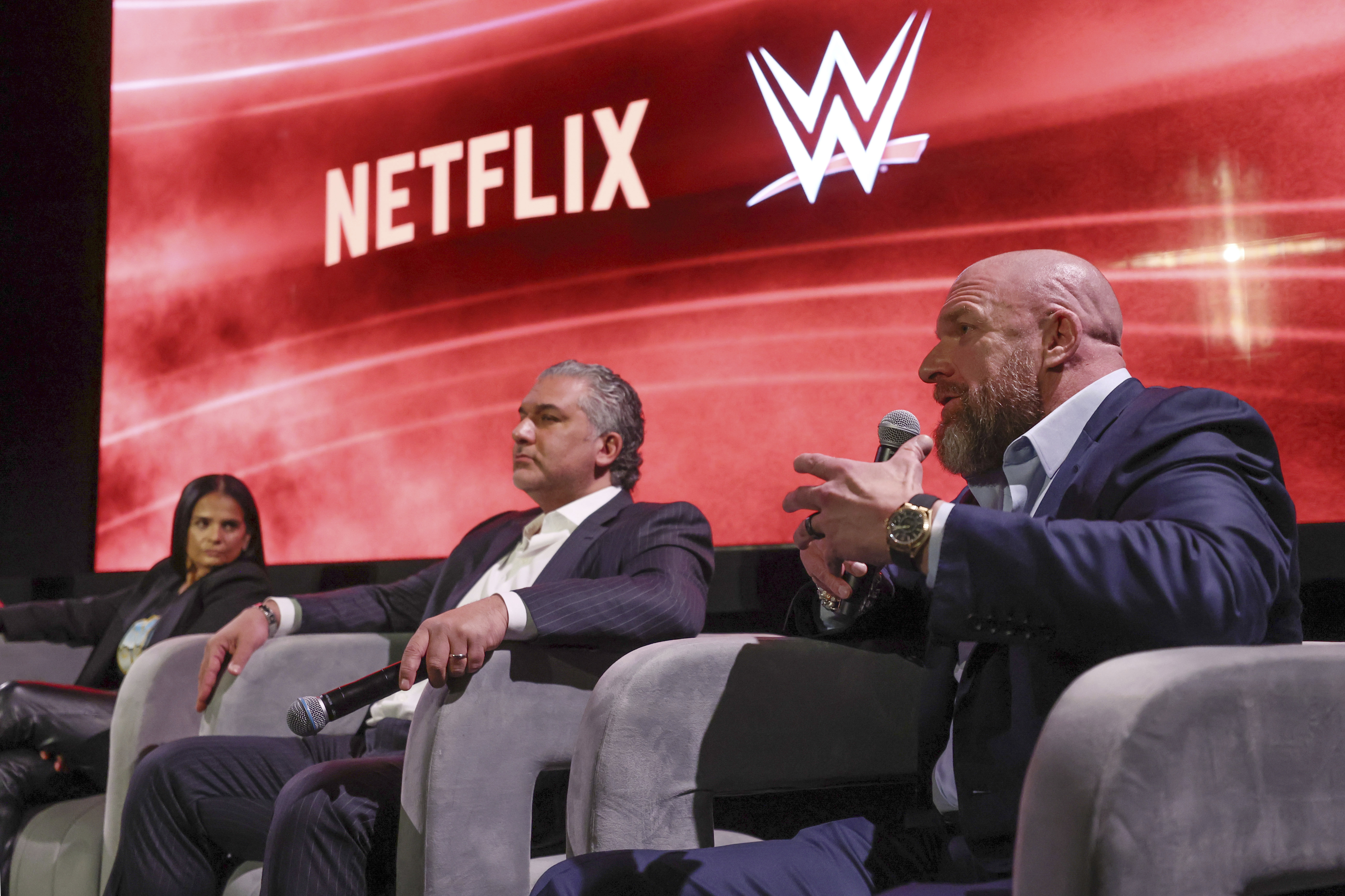 From left, Netflix Chief Content Officer Bela Bajaria, WWE President Nick Khan and WWE Chief Content Officer Paul "Triple H" Levesque discuss the World Wrestling Entertainment and Netflix during an event at Netflix's headquarters in Los Angeles on Dec. 3, 2024. 