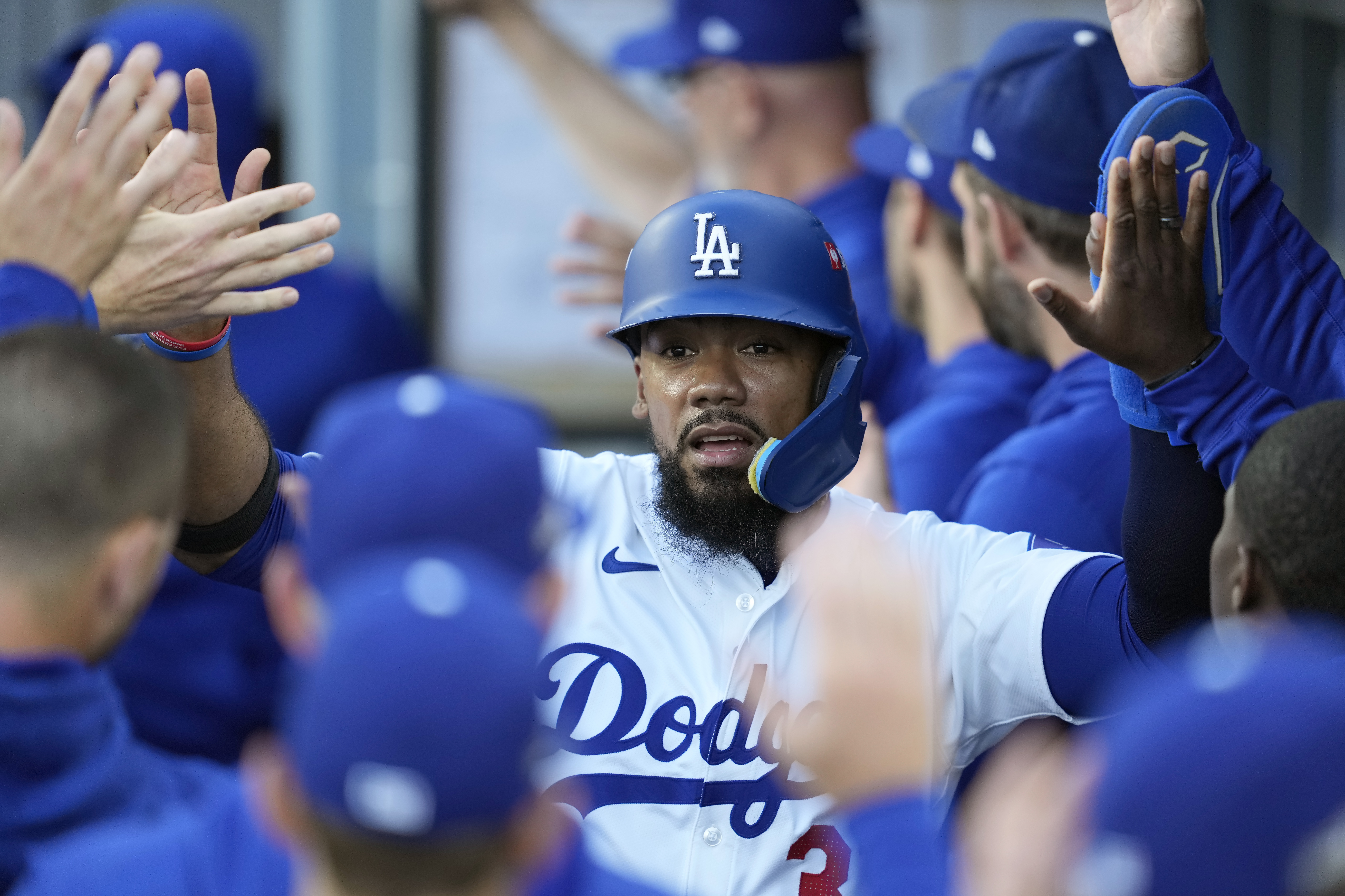 FILE - Los Angeles Dodgers' Teoscar Hernández is high-fived in the dugout after scoring on a sacrifice fly ball by Gavin Lux during the second inning in Game 2 of a baseball NL Division Series against the San Diego Padres, Sunday, Oct. 6, 2024, in Los Angeles.
