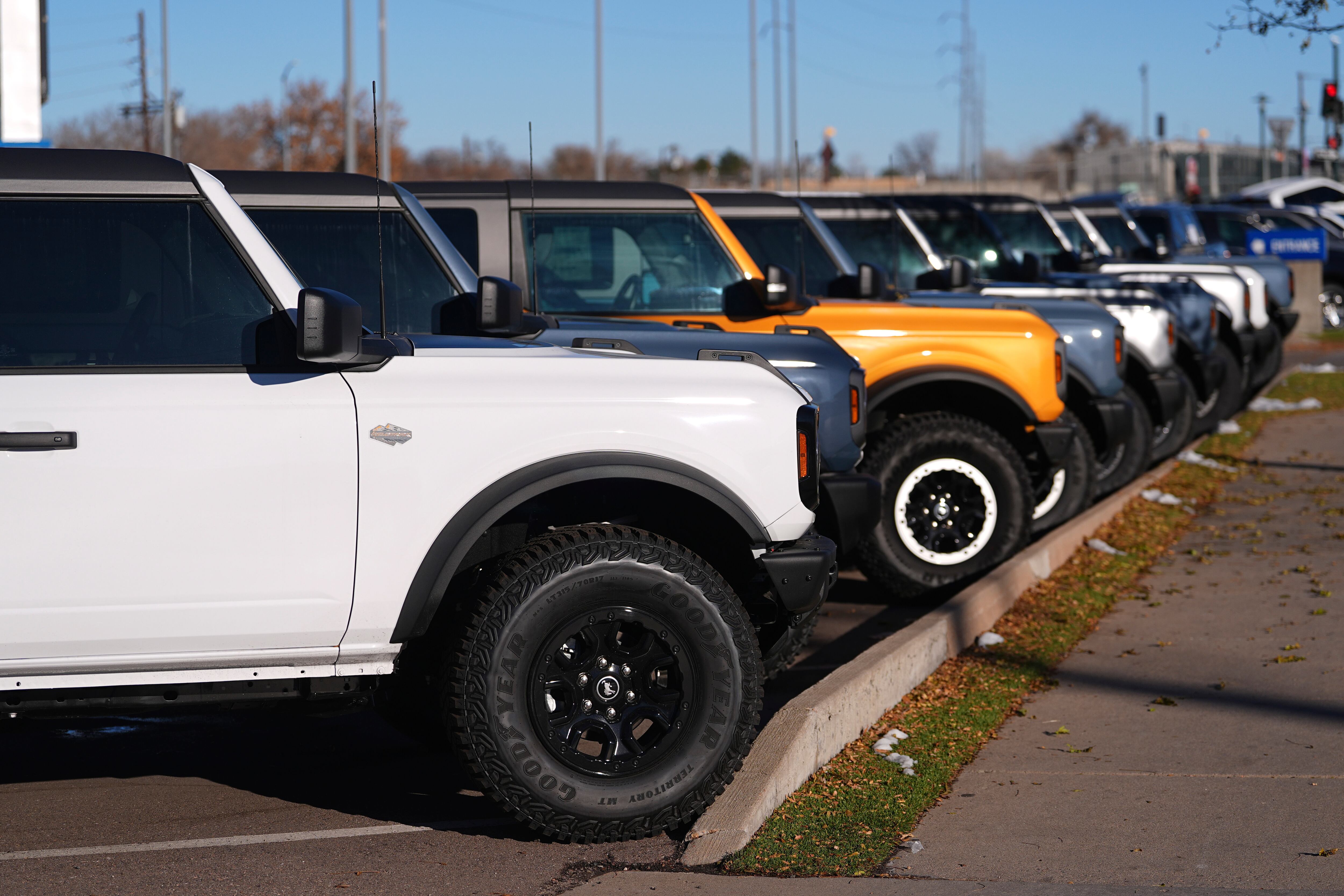 A long line of unsold 2024 Bronco utility vehicles sit on display at Ford dealership on Nov. 28, in southeast Denver.