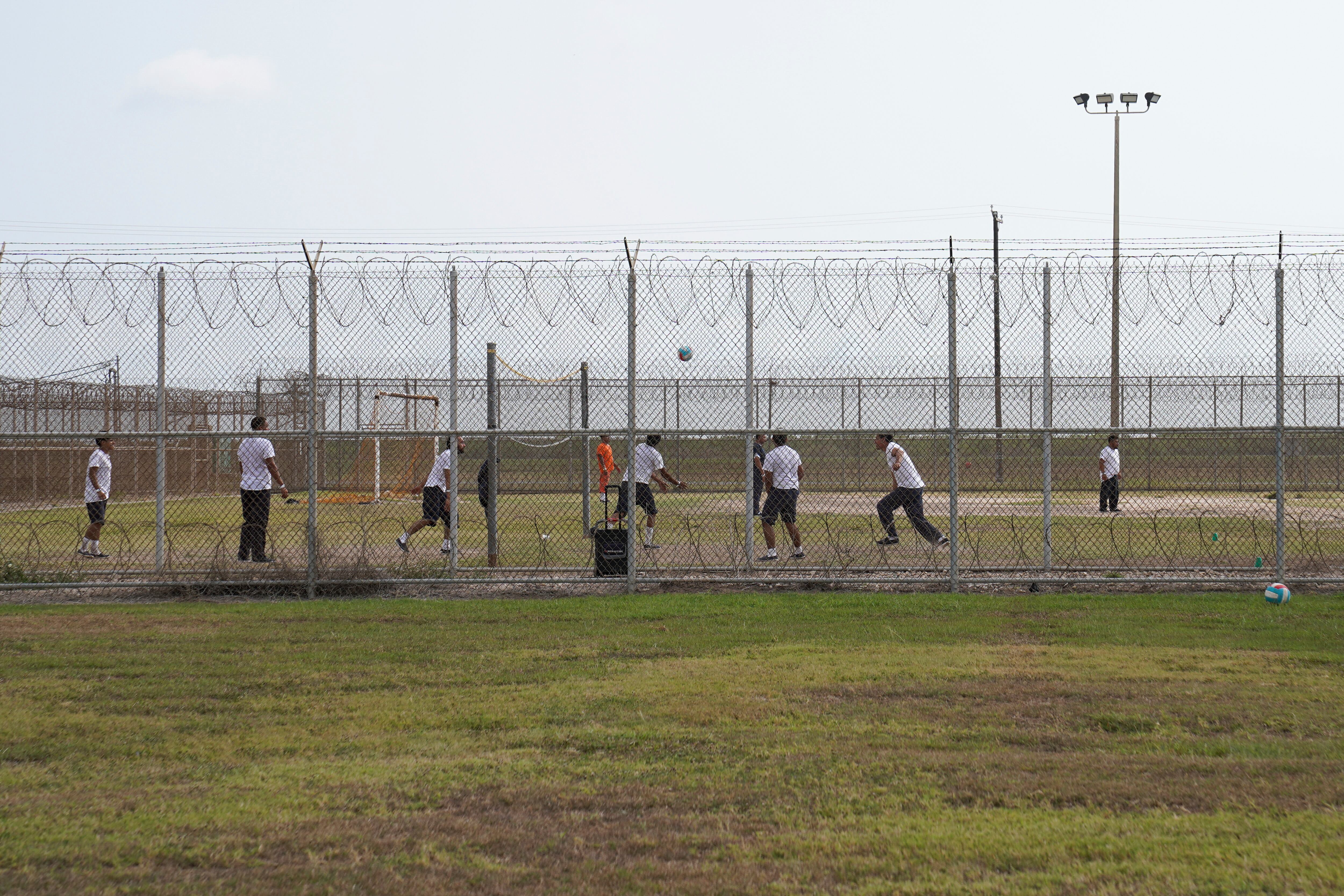 Detainees play outside during a media tour of the Port Isabel Detention Center, hosted by U.S. Immigration and Customs Enforcement Harlingen Enforcement and Removal Operations in Los Fresnos, Texas, June 10.