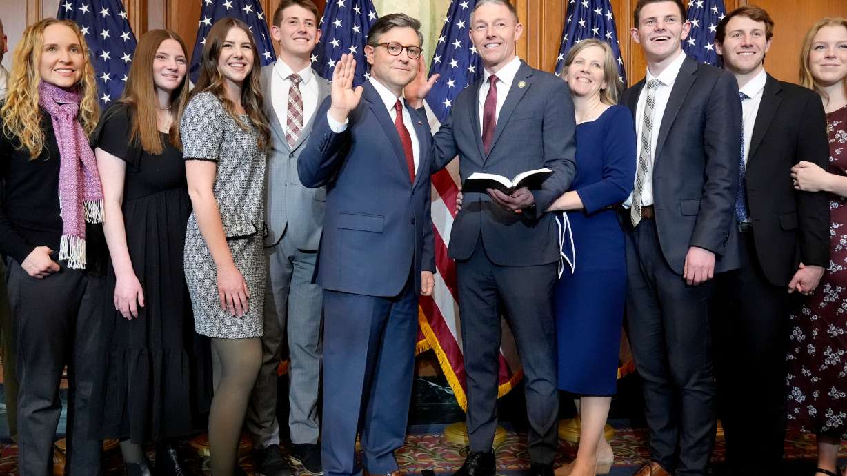 House Speaker Mike Johnson, R-La., center left, poses during a ceremonial swearing-in with Rep.-elect Mike Kennedy, R-Utah, center right, and members of Kennedy's family, in the Rayburn Room at the Capitol in Washington, Friday.