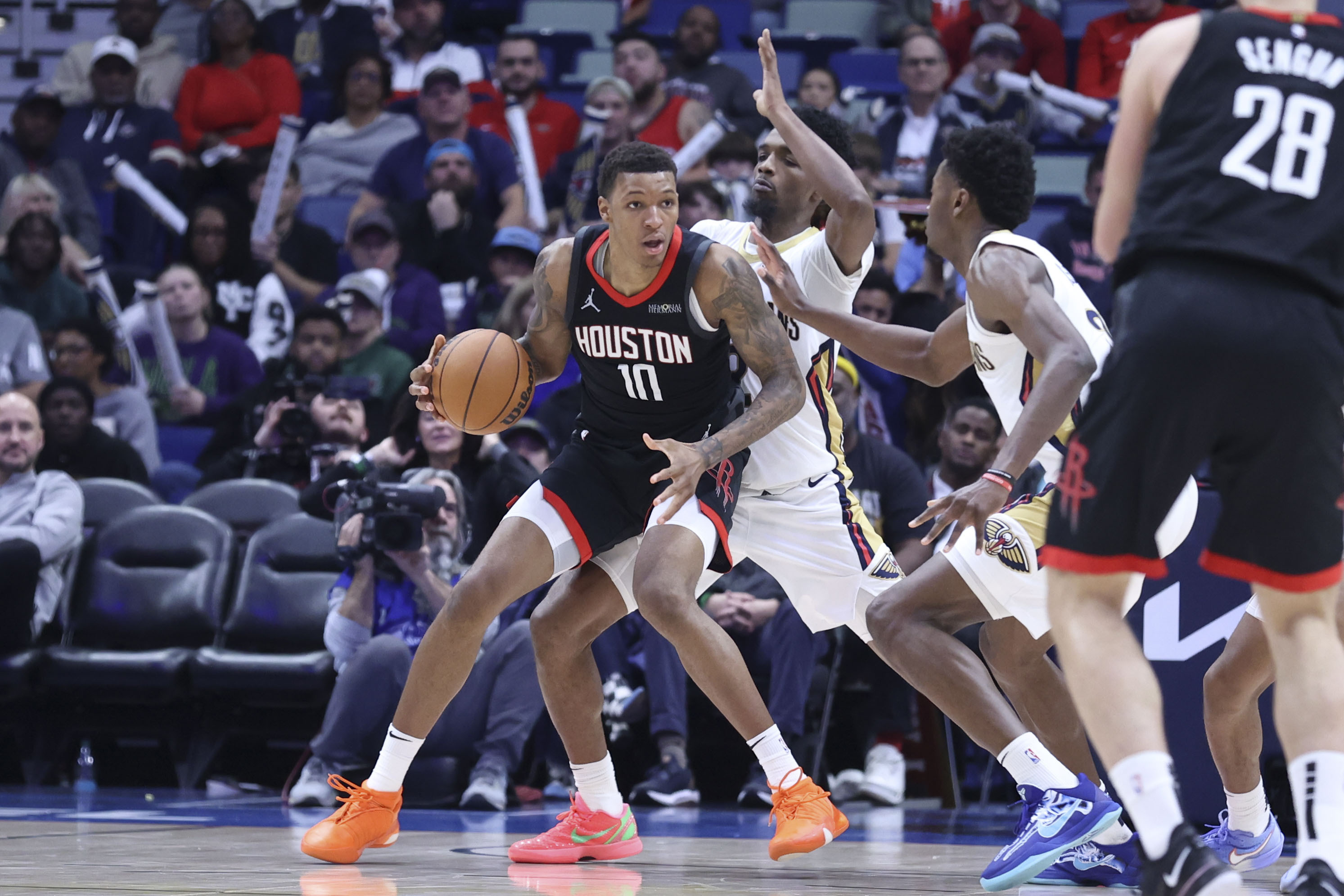 Houston Rockets forward Jabari Smith Jr. (10) tries to post up New Orleans Pelicans forward Herbert Jones, second from left, in the second half of an NBA basketball game in New Orleans, Thursday, Dec. 26, 2024.