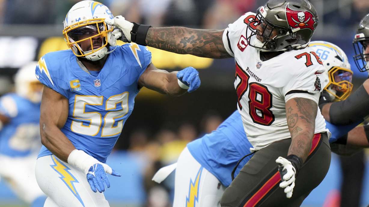 Los Angeles Chargers linebacker Khalil Mack (52) is blocked by Tampa Bay Buccaneers offensive tackle Tristan Wirfs (78) during the first half of an NFL football game Sunday, Dec. 15, 2024, in Inglewood, Calif.