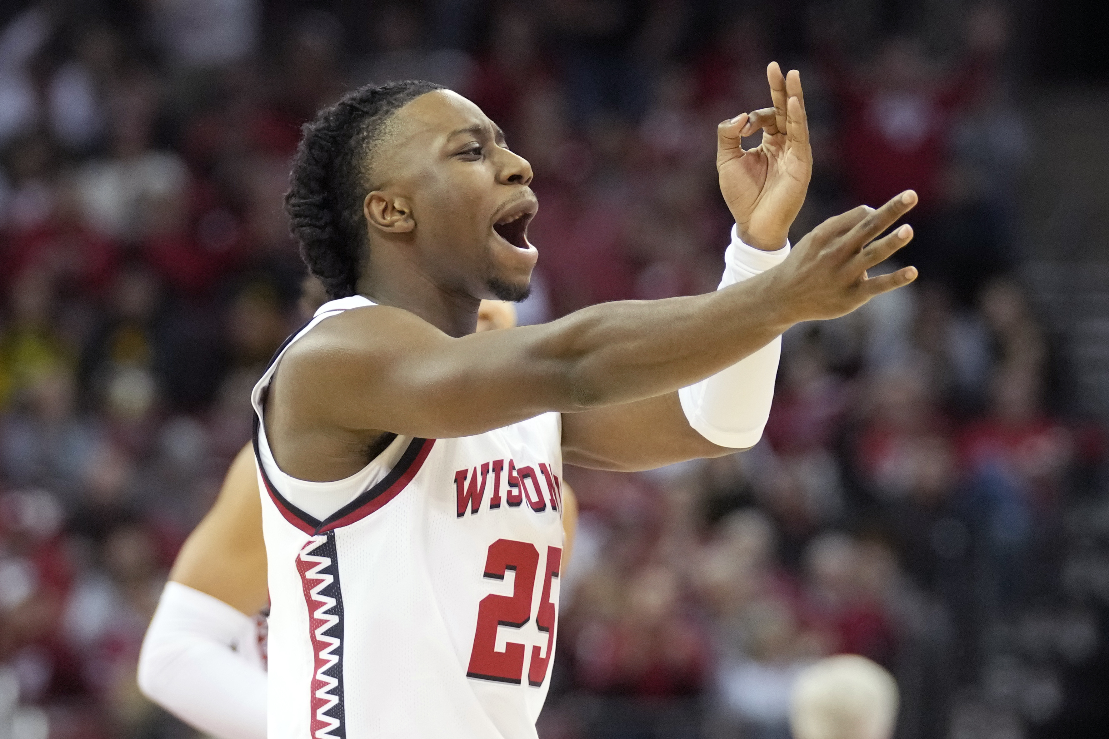 Wisconsin guard John Blackwell (25) celebrates after a 3-point basket during the first half of an NCAA college basketball game against Iowa, Friday, Jan. 3, 2025, in Madison, Wis. 