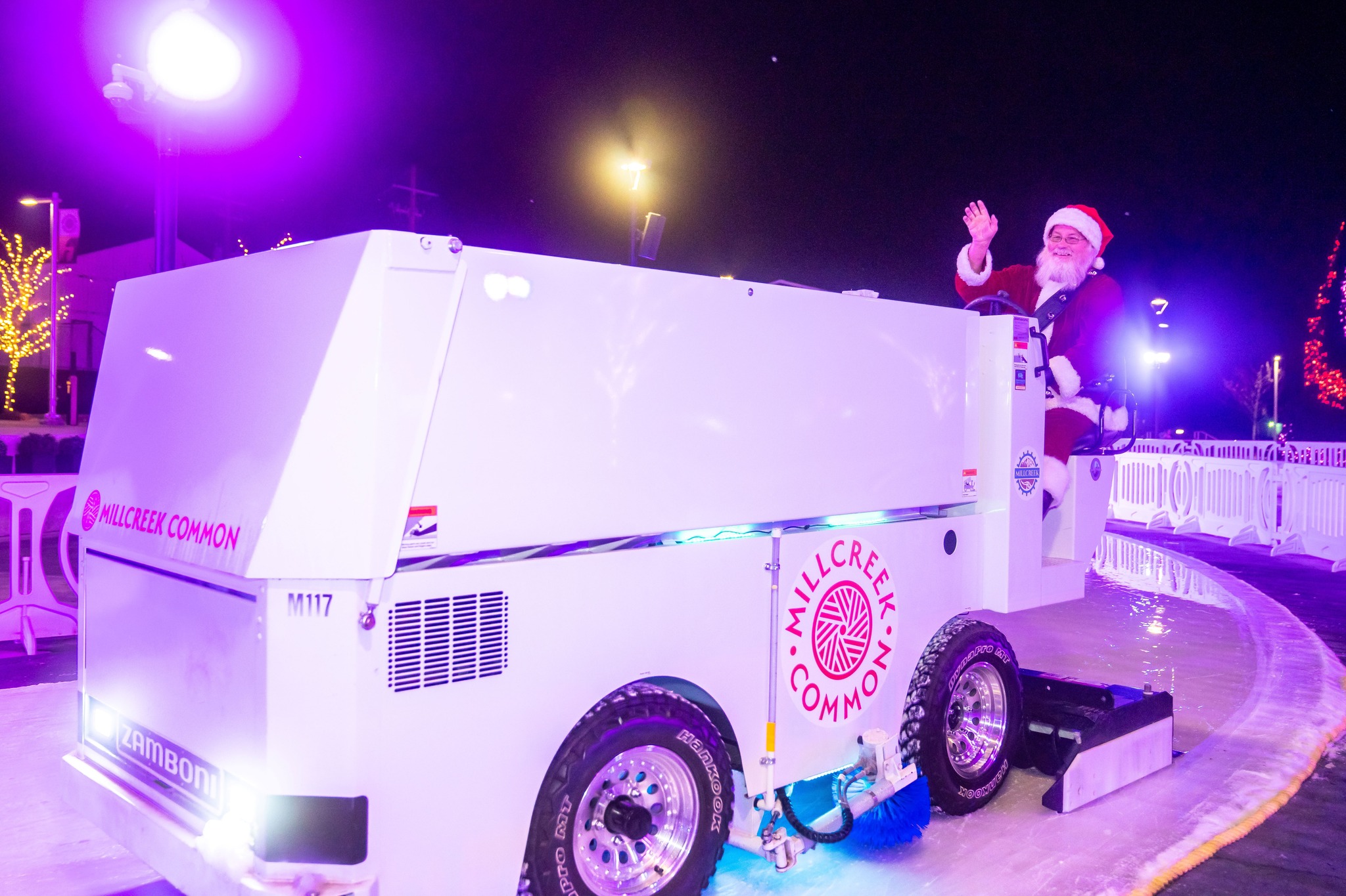 Jed Jensen drives a Zamboni in Millcreek dressed as Santa Claus.