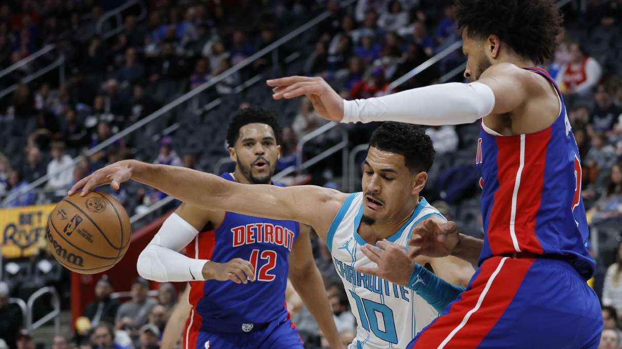 Charlotte Hornets guard Josh Green (10) tries going to the basket against Detroit Pistons guard Cade Cunningham, right, with forward Tobias Harris (12) watching the play during the first half of an NBA basketball game Friday, Jan. 3, 2025, in Detroit.