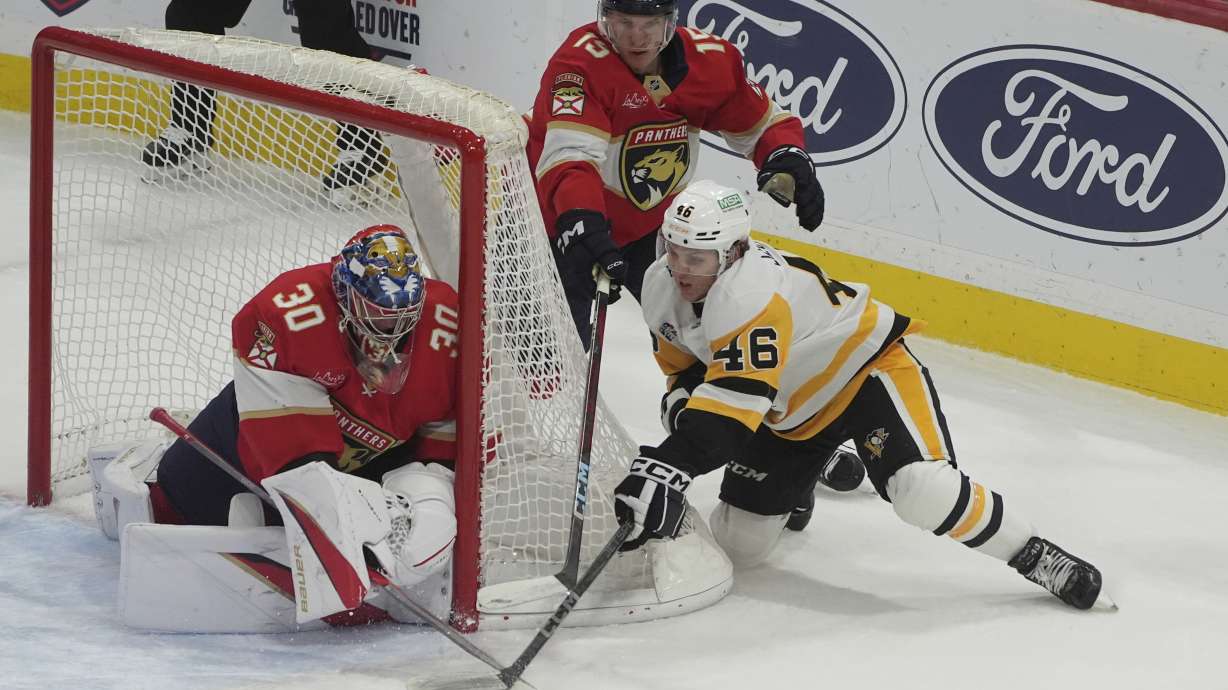 Florida Panthers goaltender Spencer Knight (30) stops a shot by Pittsburgh Penguins center Blake Lizotte (46) during the first period of an NHL hockey game, Friday, Jan. 3, 2025, in Sunrise, Fla.