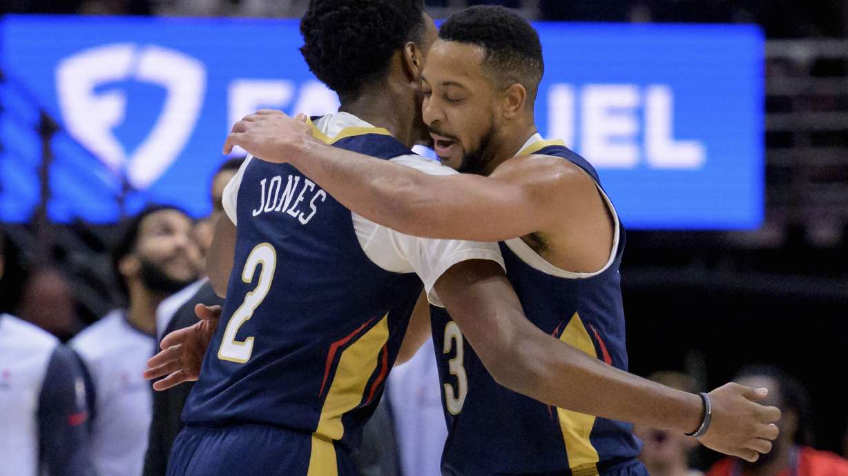 New Orleans Pelicans guard CJ McCollum (3) celebrates a 3-point basket with forward Herbert Jones (2) during the first half of an NBA basketball game against the Washington Wizards in New Orleans, Friday, Jan. 3, 2025.
