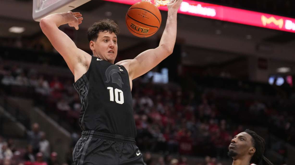 Michigan State center Szymon Zapala (10) dunks in front of Ohio State forward Aaron Bradshaw, right, in the second half of an NCAA college basketball game Friday, Jan. 3, 2025, in Columbus, Ohio.
