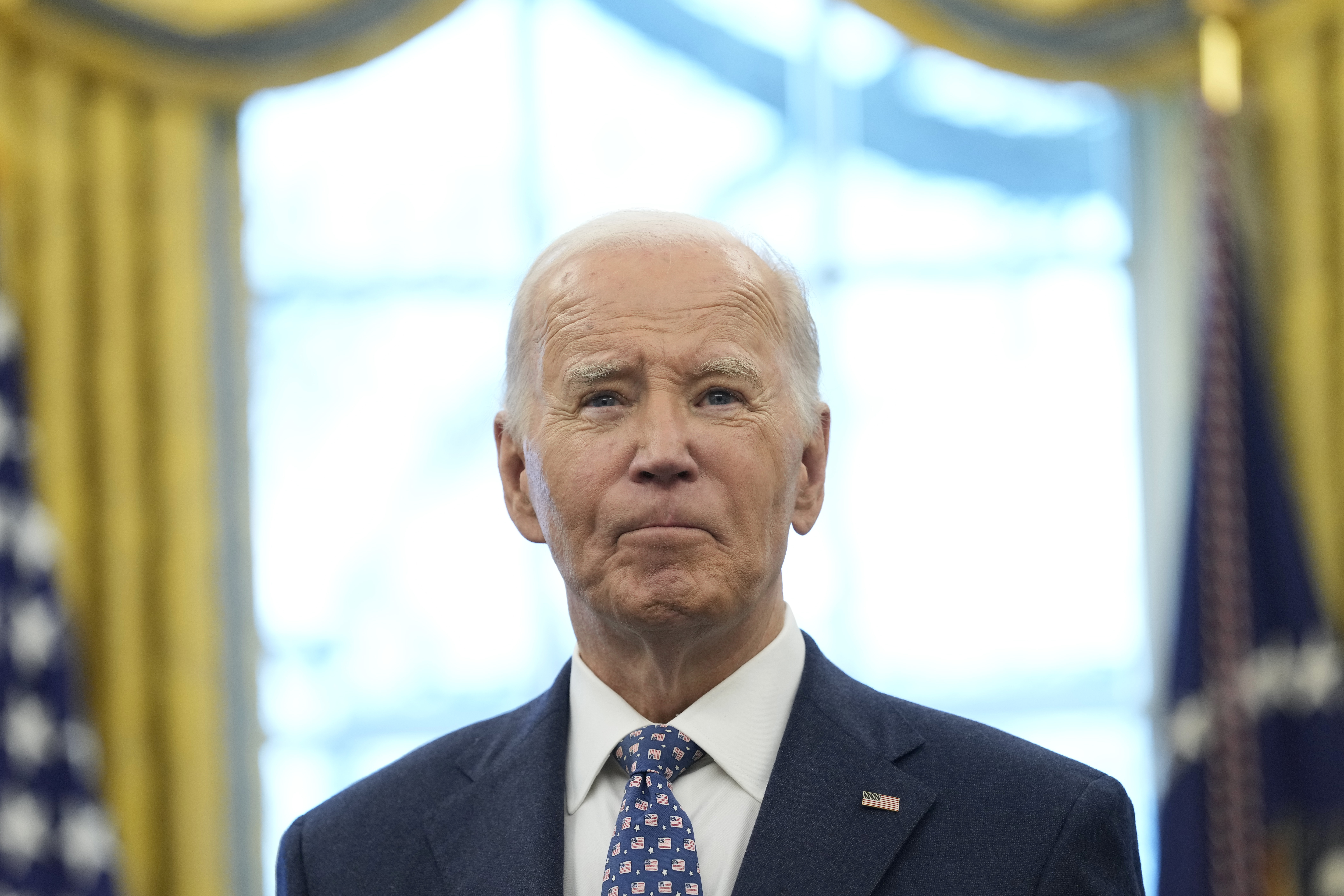 President Joe Biden pauses during a photo opportunity with Medal of Valor recipients in the Oval Office of the White House in Washington Friday.