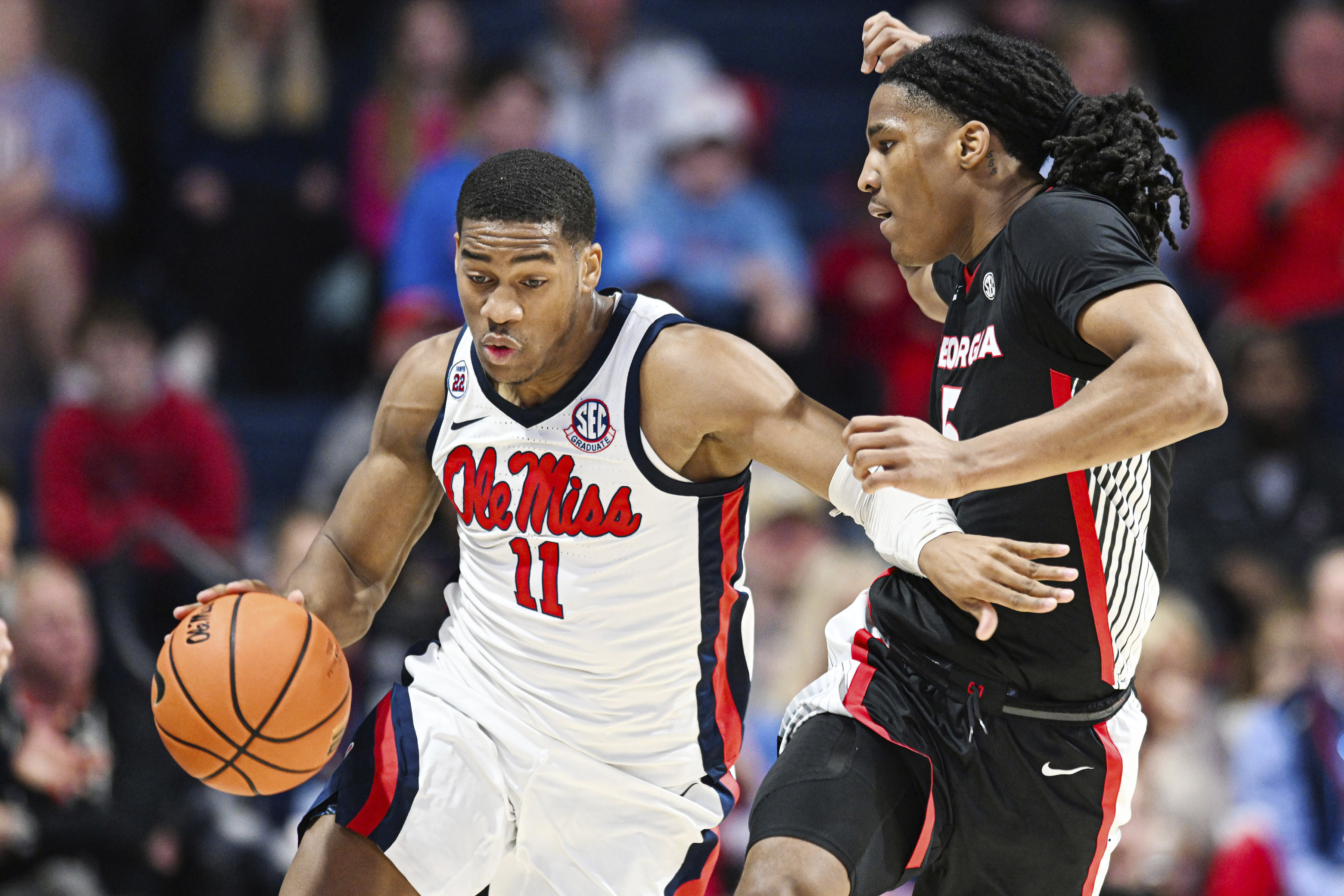 Mississippi guard Matthew Murrell (11) brings the ball up court against Georgia guard Silas Demary Jr. (5) during the first half of an NCAA college basketball game in Oxford, Miss., Saturday, Jan. 4, 2025. 