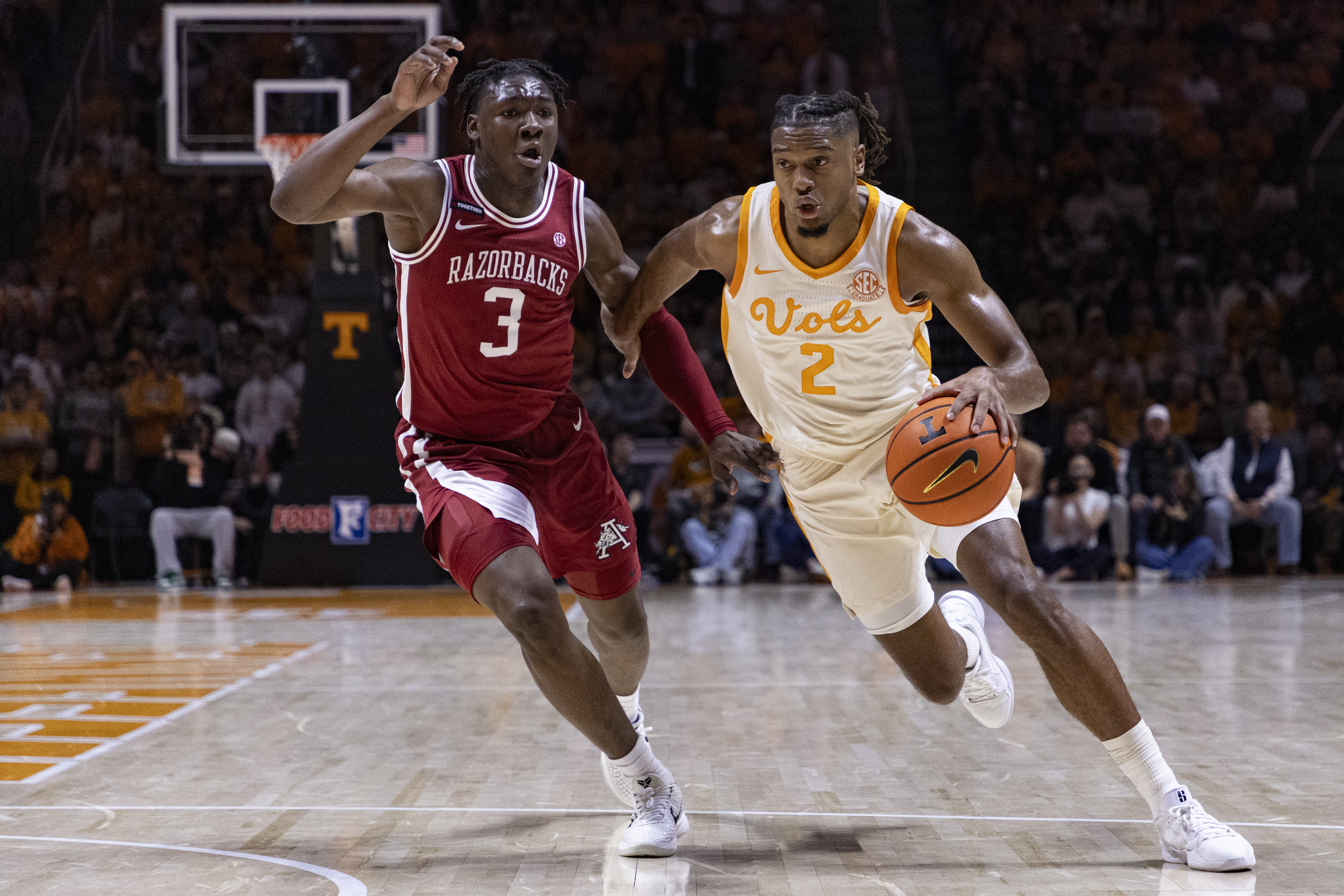 Tennessee guard Chaz Lanier (2) drives against Arkansas forward Adou Thiero (3) during the first half of an NCAA college basketball game Saturday, Jan. 4, 2025, in Knoxville, Tenn.