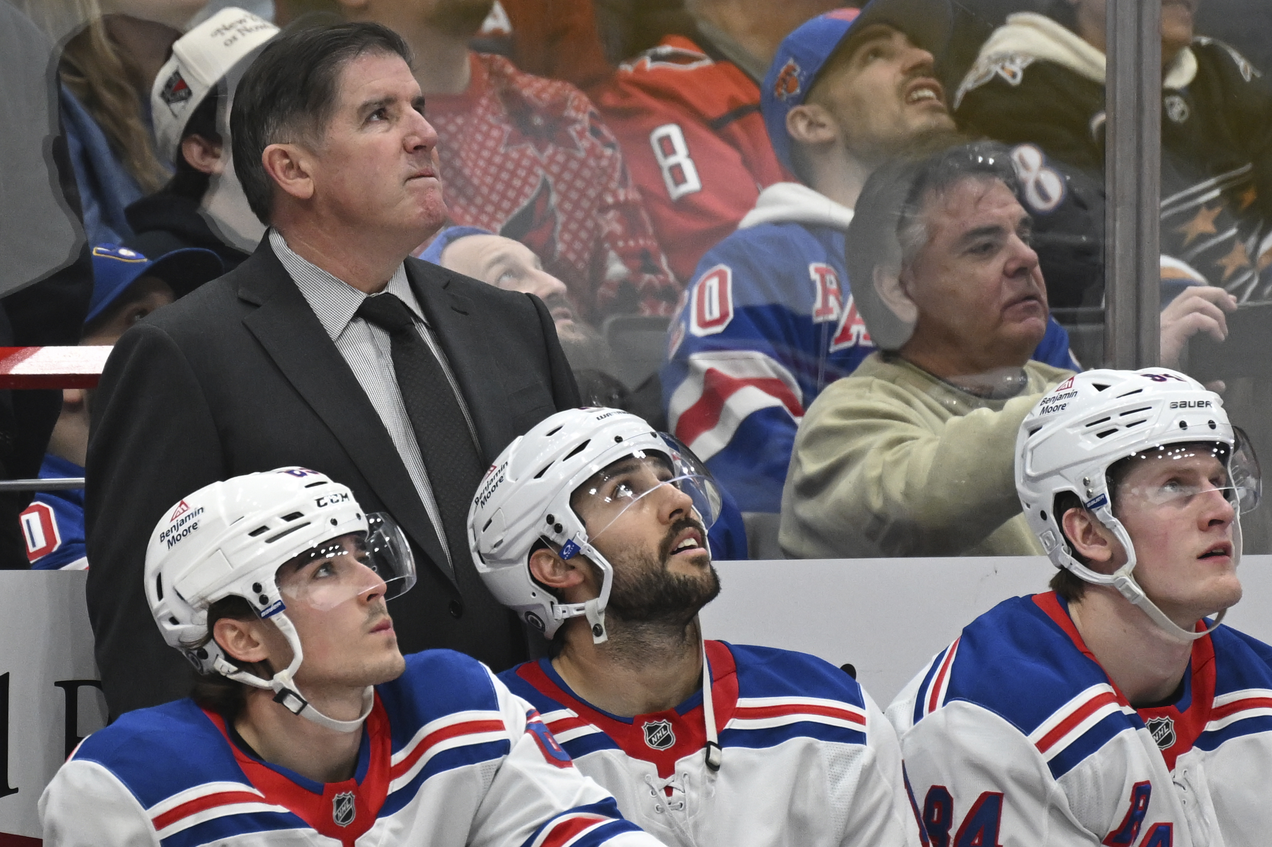 New York Rangers head coach Peter Laviolette, rear left, watches a replay during the second period of an NHL hockey game against the Washington Capitals, Saturday, Jan. 4, 2025, in Washington.