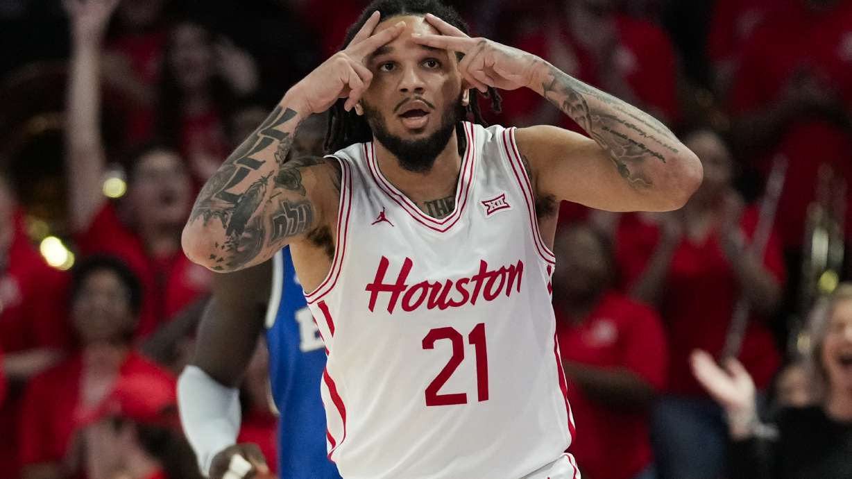 Houston guard Emanuel Sharp (21) reacts after making a 3-pointer during the first half of an NCAA college basketball game against the Brigham Young in Houston, Saturday, Jan. 4, 2025.