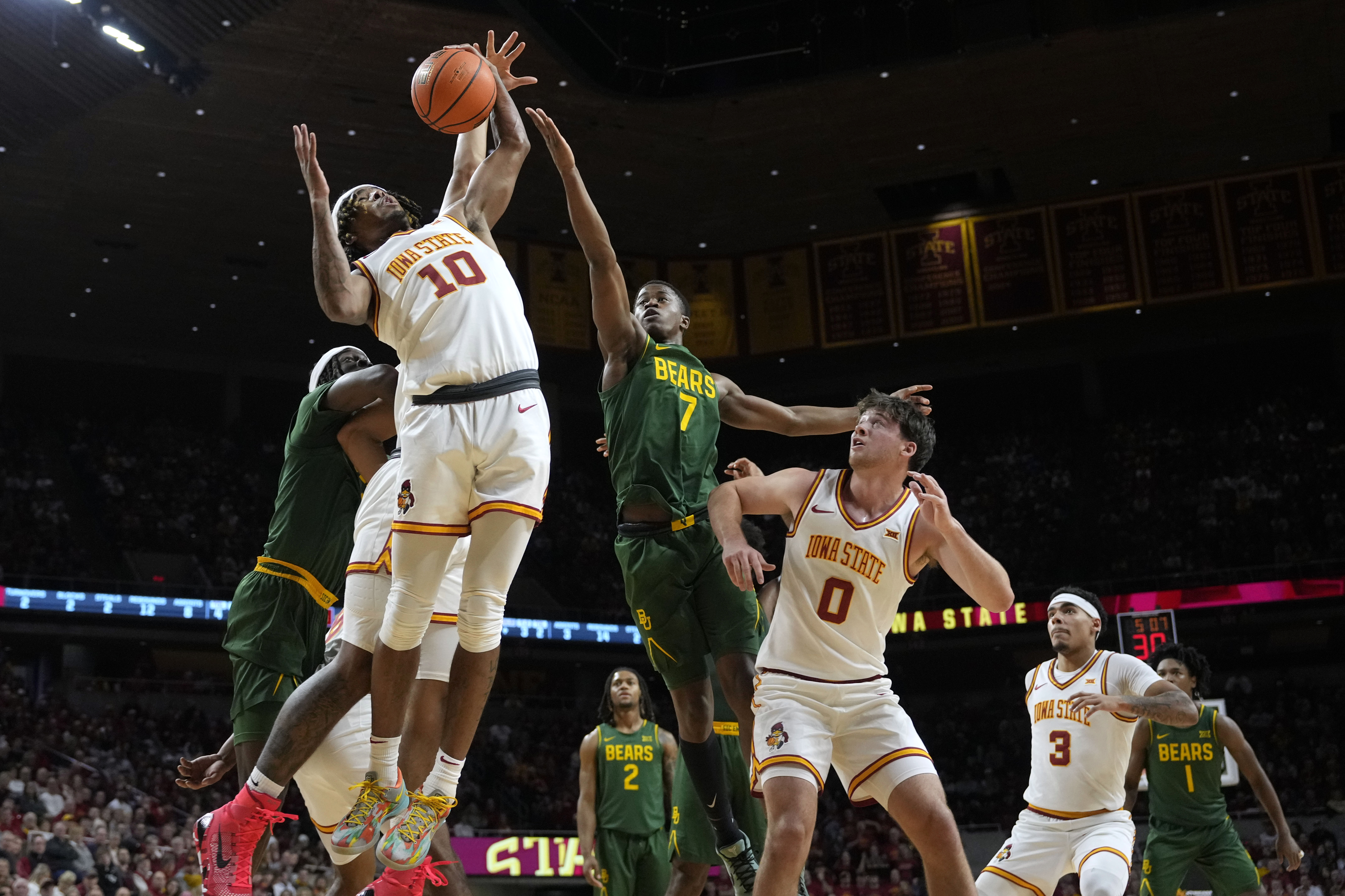 Iowa State guard Keshon Gilbert (10) grabs a rebound over Baylor guard VJ Edgecombe (7) during the first half of an NCAA college basketball game Saturday, Jan. 4, 2025, in Ames, Iowa.