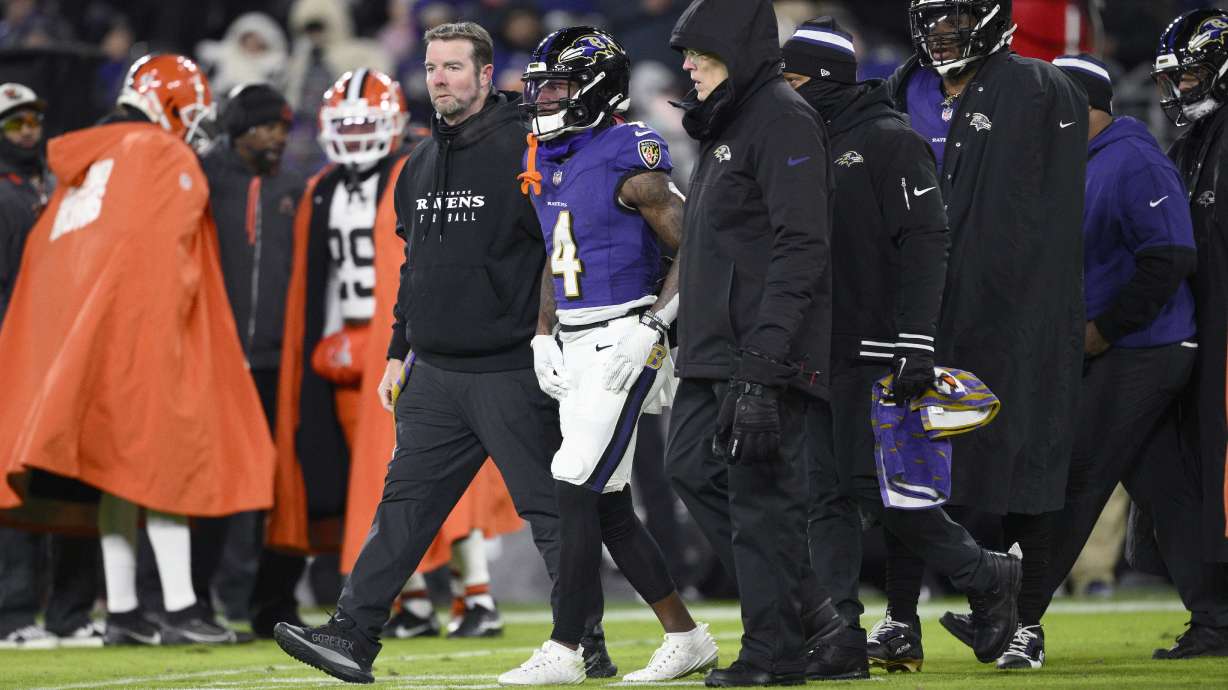 Baltimore Ravens wide receiver Zay Flowers is helped off the field after being injured during the first half of an NFL football game against the Cleveland Browns Saturday, Jan. 4, 2025, in Baltimore.