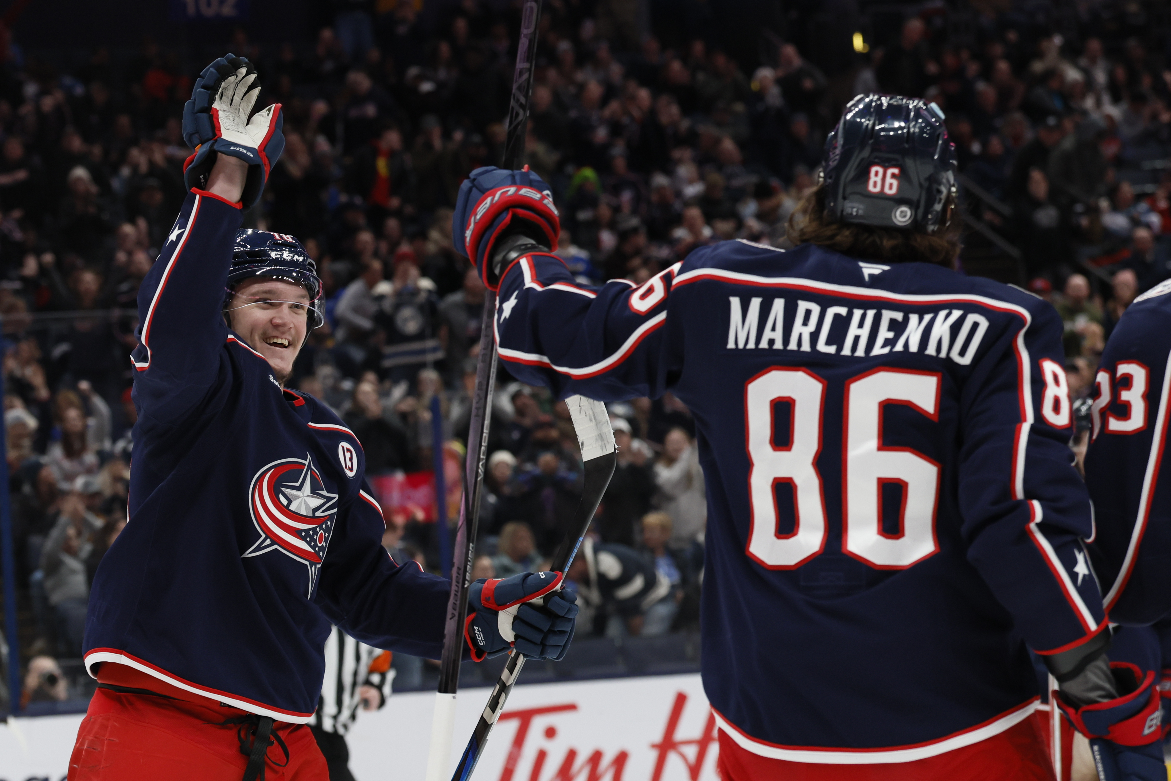 Columbus Blue Jackets' Dmitri Voronkov, left, congratulates Kirill Marchenko on his goal against the St. Louis Blues during the second period of an NHL hockey game Saturday, Jan. 4, 2025, in Columbus, Ohio.