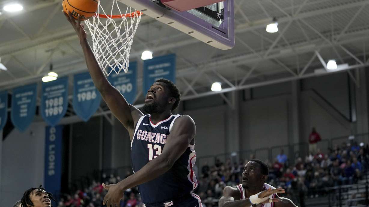 Gonzaga forward Graham Ike (13) goes to the basket against Loyola Marymount center Rick Issanza (22) during the first half of an NCAA college basketball game in Los Angeles, Saturday, Jan. 4, 2025.