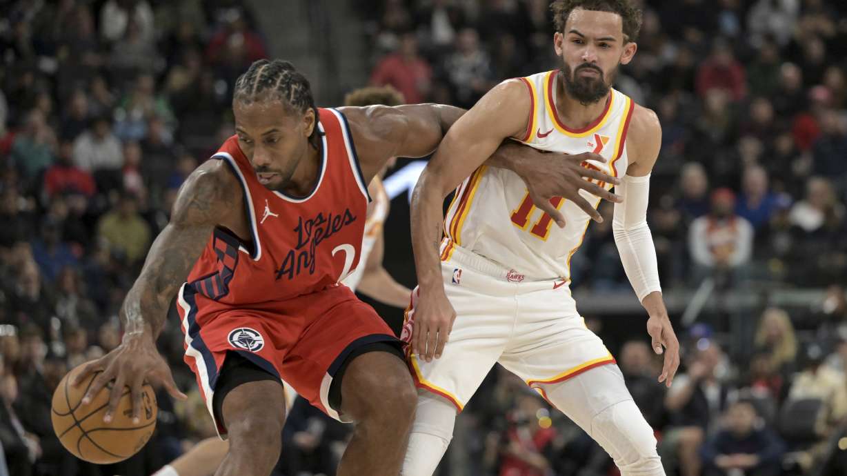 Los Angeles Clippers forward Kawhi Leonard, left, steals the ball from Atlanta Hawks guard Trae Young during the first half of an NBA basketball game Saturday, Jan. 4, 2025, in Los Angeles.