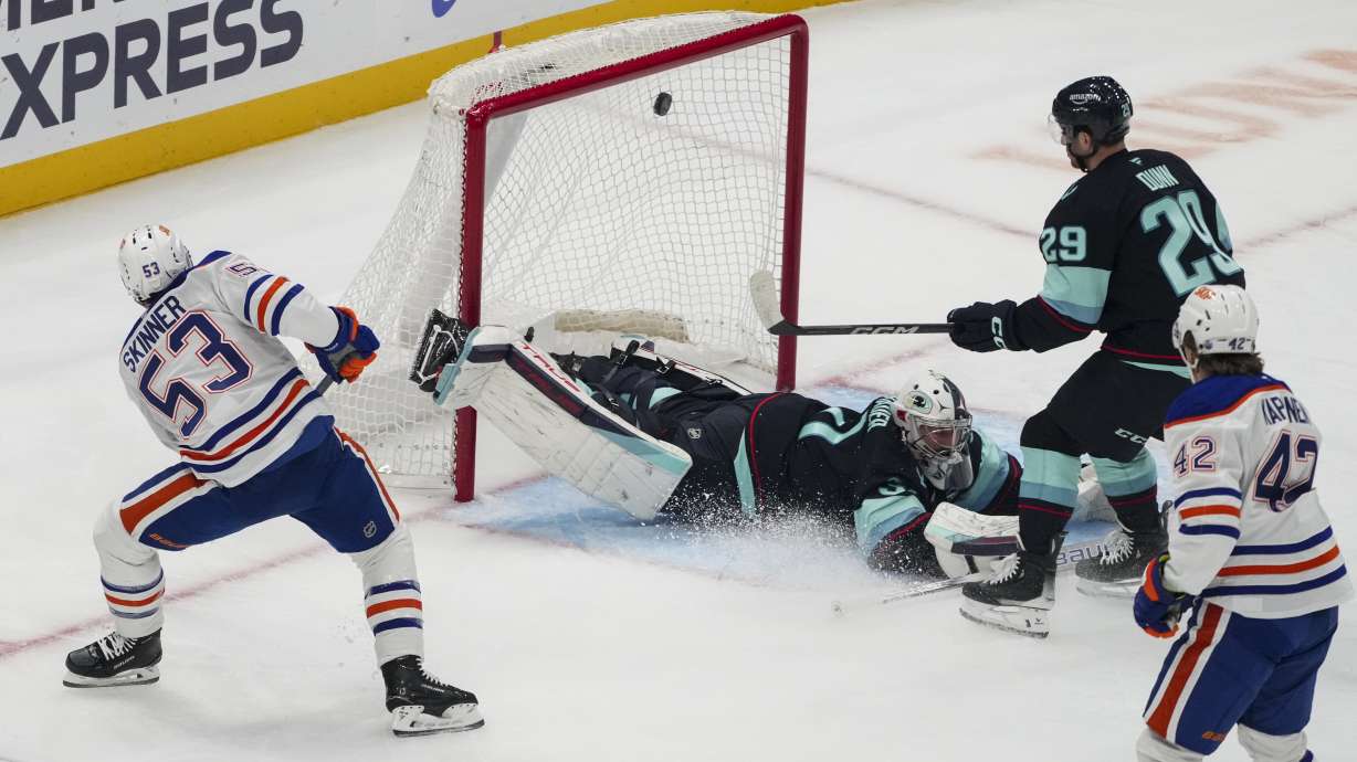 Edmonton Oilers center Jeff Skinner (53) scores against Seattle Kraken goaltender Philipp Grubauer, center, as Kraken defenseman Vince Dunn (29) looks on during the first period of an NHL hockey game Saturday, Jan. 4, 2025, in Seattle.