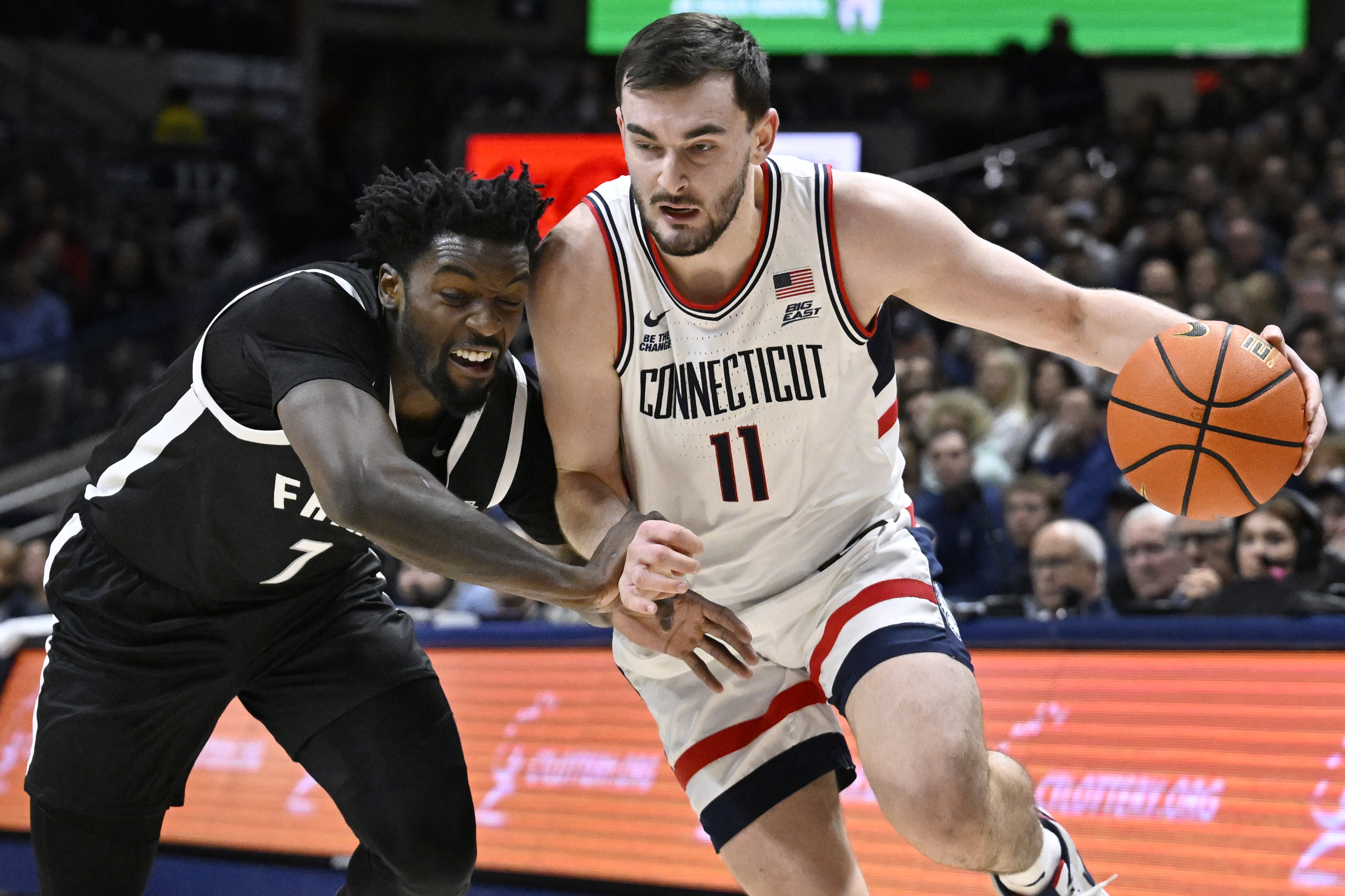 No. 11 UConn erases a 14-point deficit to top Providence 87-84 and stay beaten in the Big East