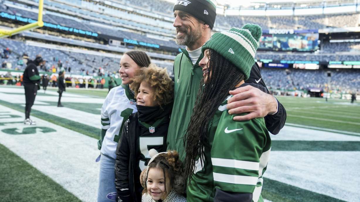 New York Jets quarterback Aaron Rodgers poses with fans before an NFL football game against the Miami Dolphins, Sunday, Jan. 5, 2024, in East Rutherford, N.J.