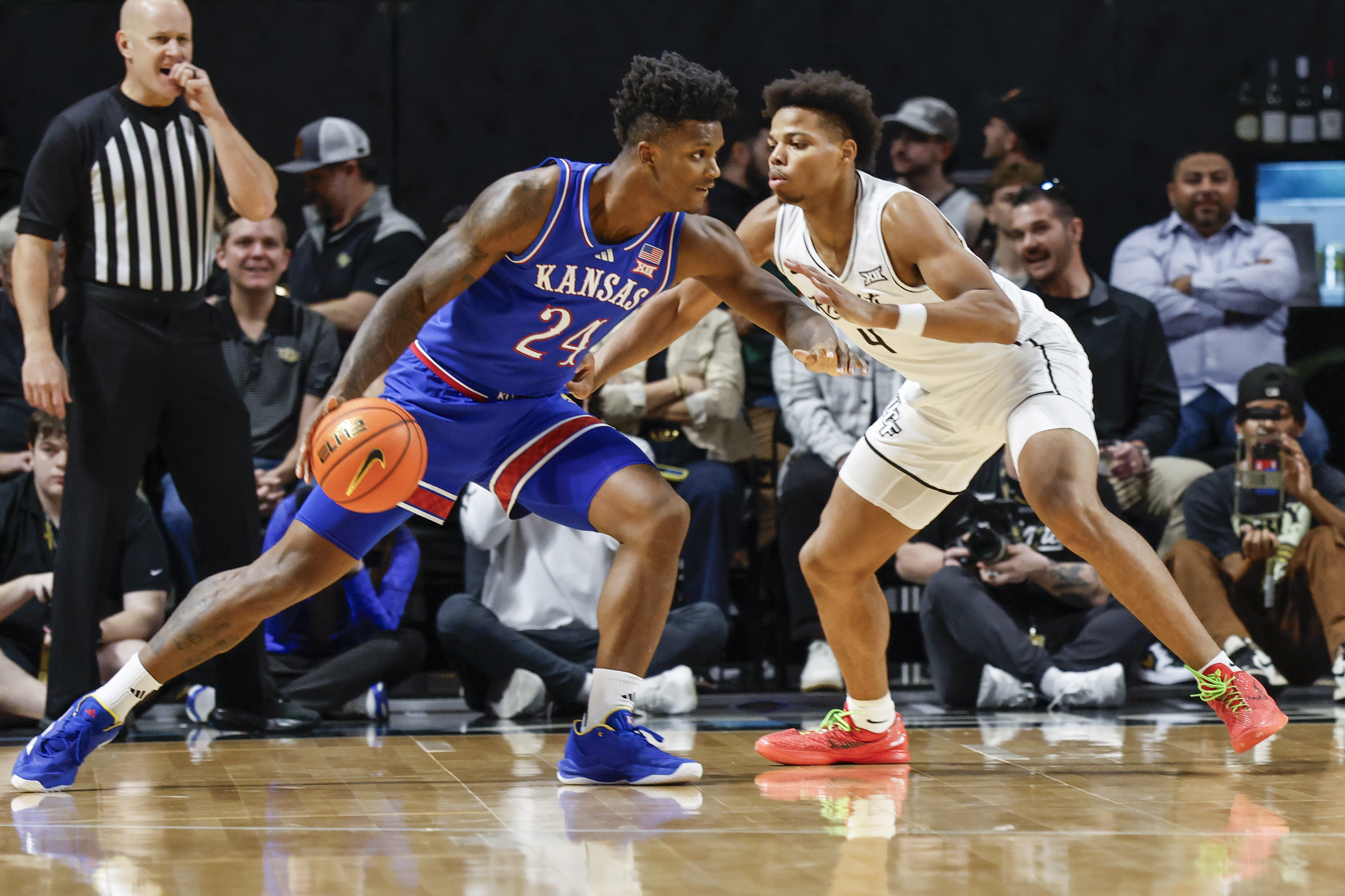 Kansas forward KJ Adams Jr. (24) drives against Central Florida guard Keyshawn Hall (4) during the first half of an NCAA college basketball game, Sunday, Jan. 5, 2025, in Orlando, Fla.