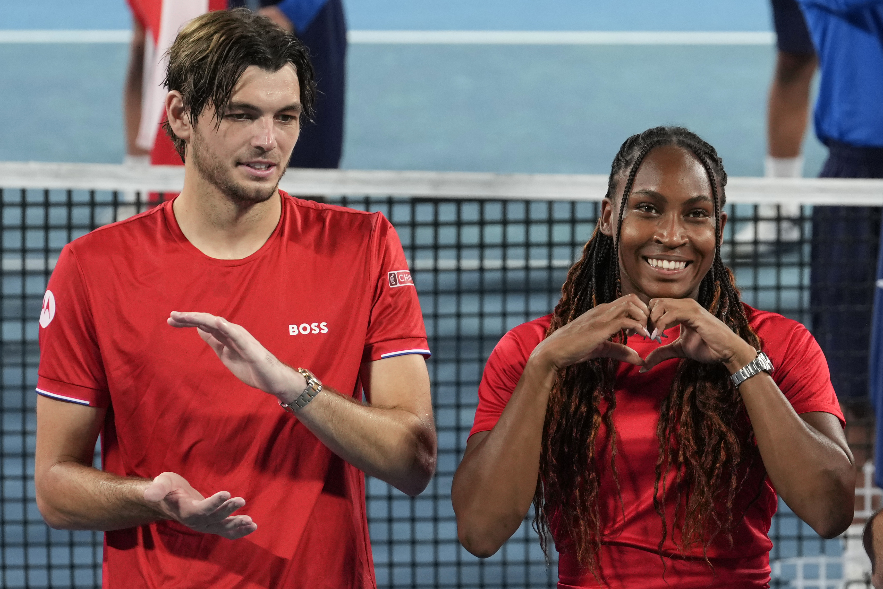 Coco Gauff of the U.S., right, and teammate Taylor Fritz gesture during the award ceremony after the U.S. team defeated Poland in their final match at the United Cup tennis tournament in Sydney, Australia, Sunday, Jan. 5, 2025.