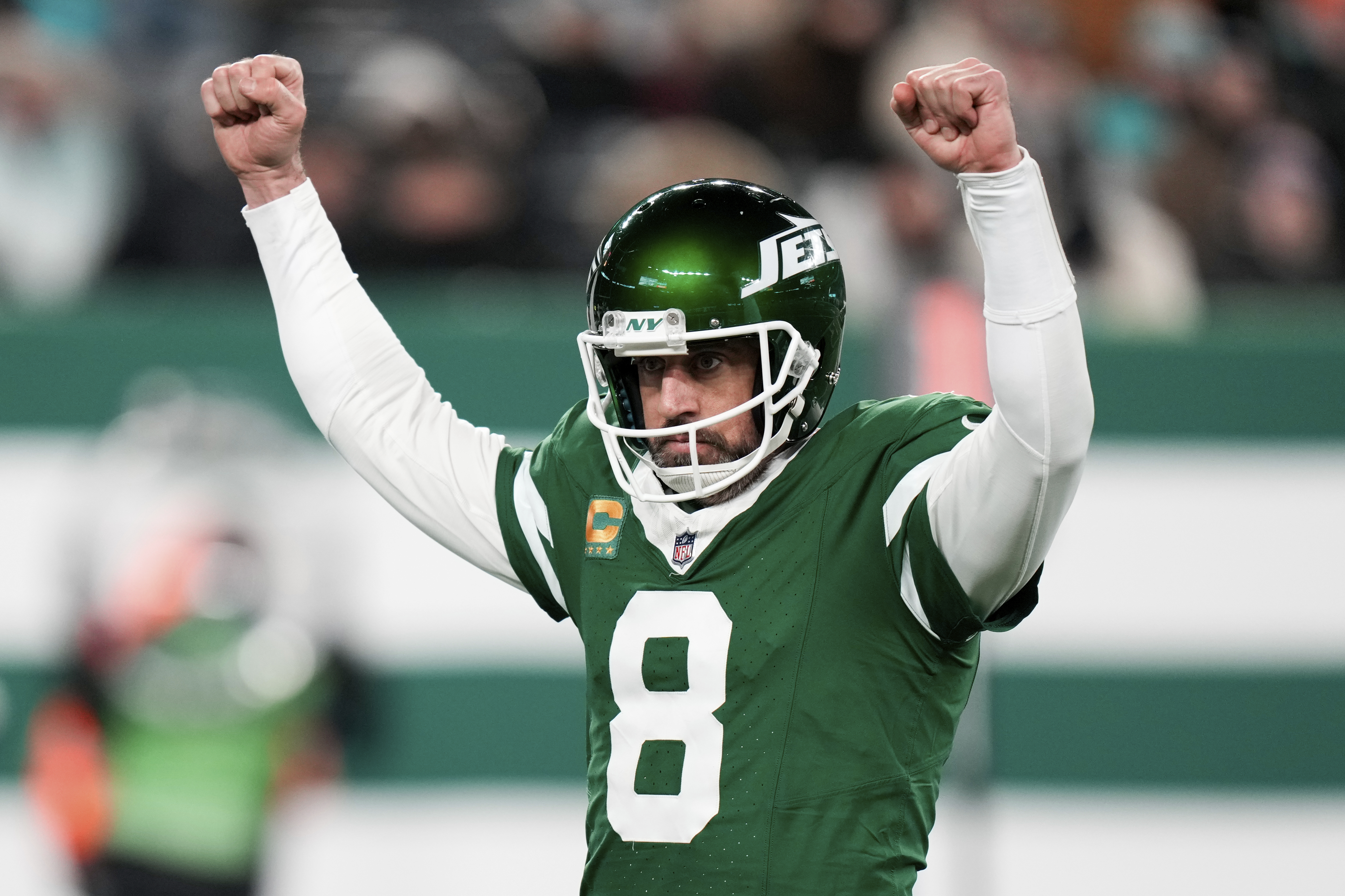 New York Jets quarterback Aaron Rodgers reacts after scoring his second touchdown pass during the first half of an NFL football game against the Miami Dolphins, Sunday, Jan. 5, 2025, in East Rutherford, N.J. 