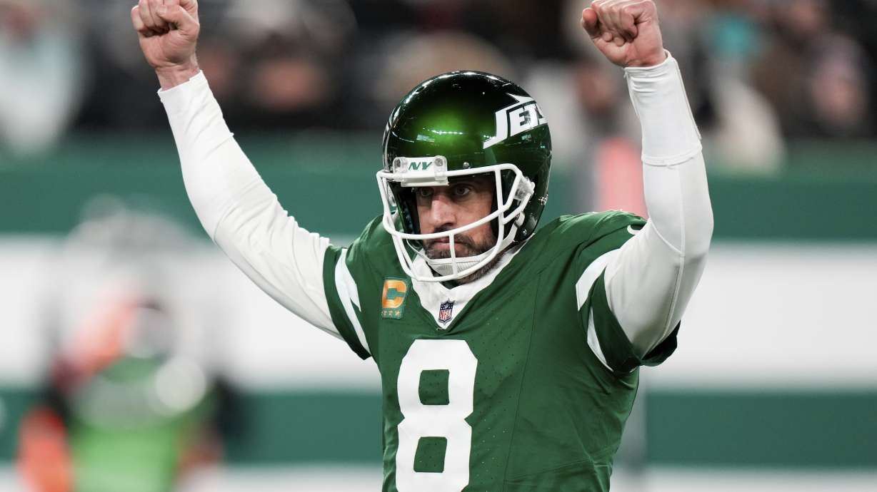New York Jets quarterback Aaron Rodgers reacts after scoring his second touchdown pass during the first half of an NFL football game against the Miami Dolphins, Sunday, Jan. 5, 2025, in East Rutherford, N.J.