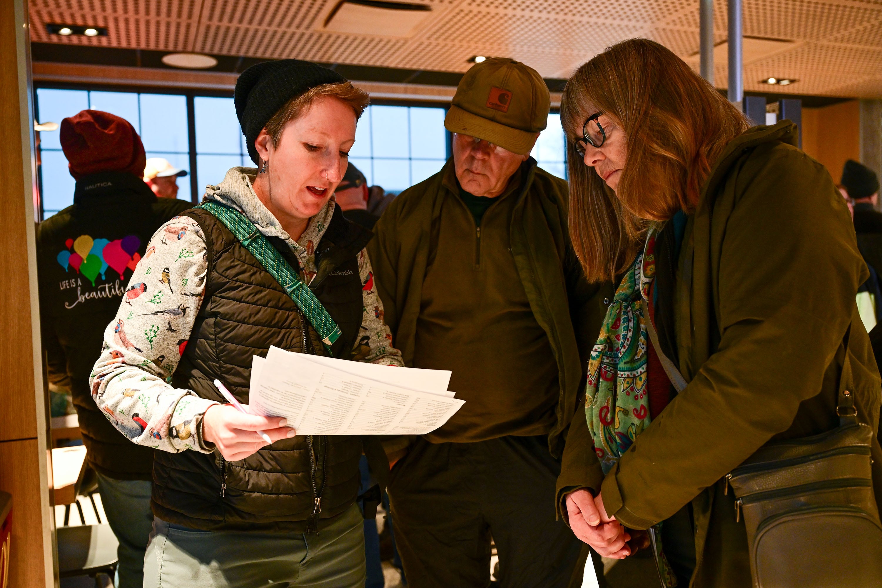 Keeli Marvel gives Dave and Jennifer Heldenbrand, of Mapleton, some instructions as they and several eager bird-watchers gather at a McDonald's in Payson to participate in the annual Christmas Bird Count on Dec. 28, 2024.