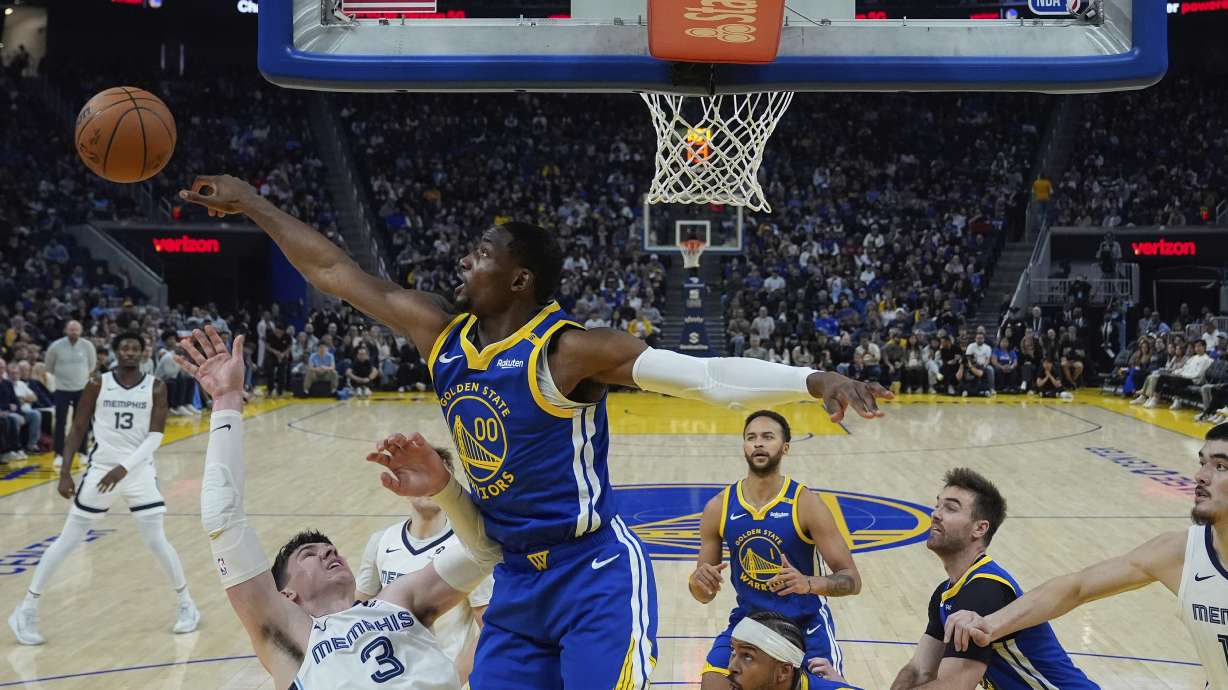 Golden State Warriors forward Jonathan Kuminga (00) blocks a shot by Memphis Grizzlies forward Jake LaRavia (3) during the first half of an NBA basketball game Saturday, Jan. 4, 2025, in San Francisco.