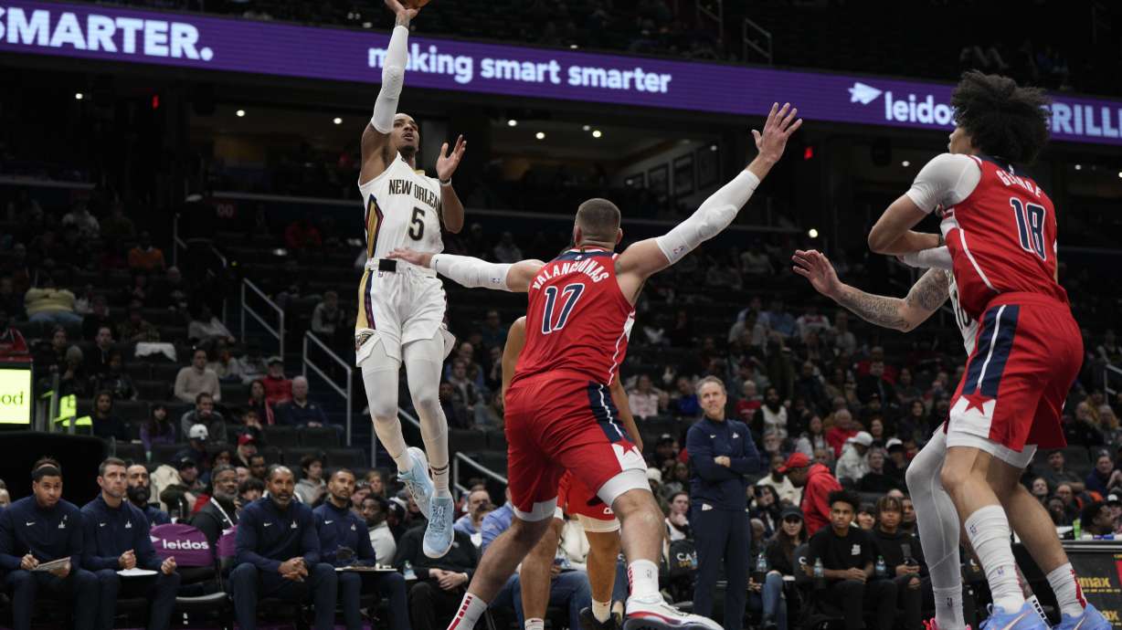 New Orleans Pelicans guard Dejounte Murray (5) goes up to shoot against Washington Wizards center Jonas Valanciunas (17) during the first half of an NBA basketball game Sunday, Jan. 5, 2025, in Washington.