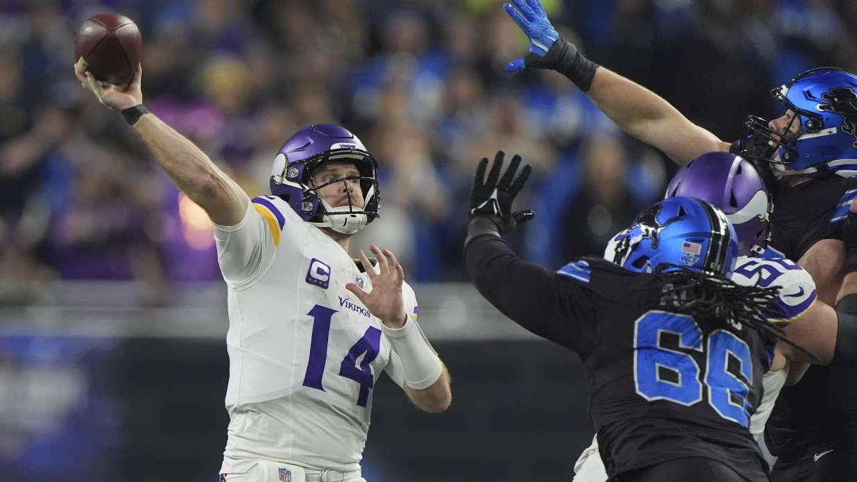 Minnesota Vikings quarterback Sam Darnold (14) throws against the Detroit Lions under pressure during the first half of an NFL football game Sunday, Jan. 5, 2025, in Detroit.