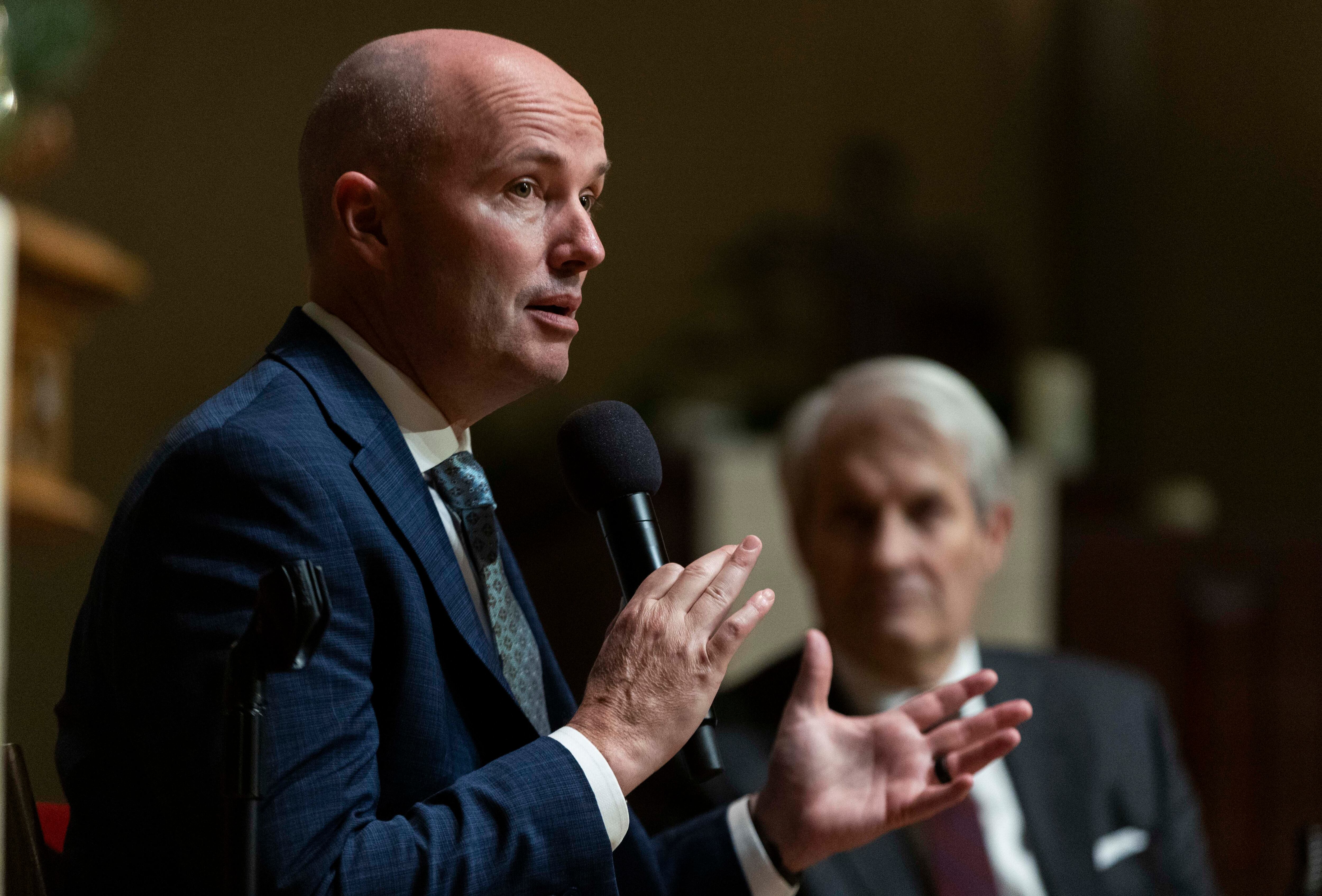 Gov. Spencer Cox speaks with retired Judge of the Court of Appeals for the District of Columbia Circuit during a Utah Interfaith Fireside panel discussion at the First Presbyterian Church of Salt Lake City on Sunday.