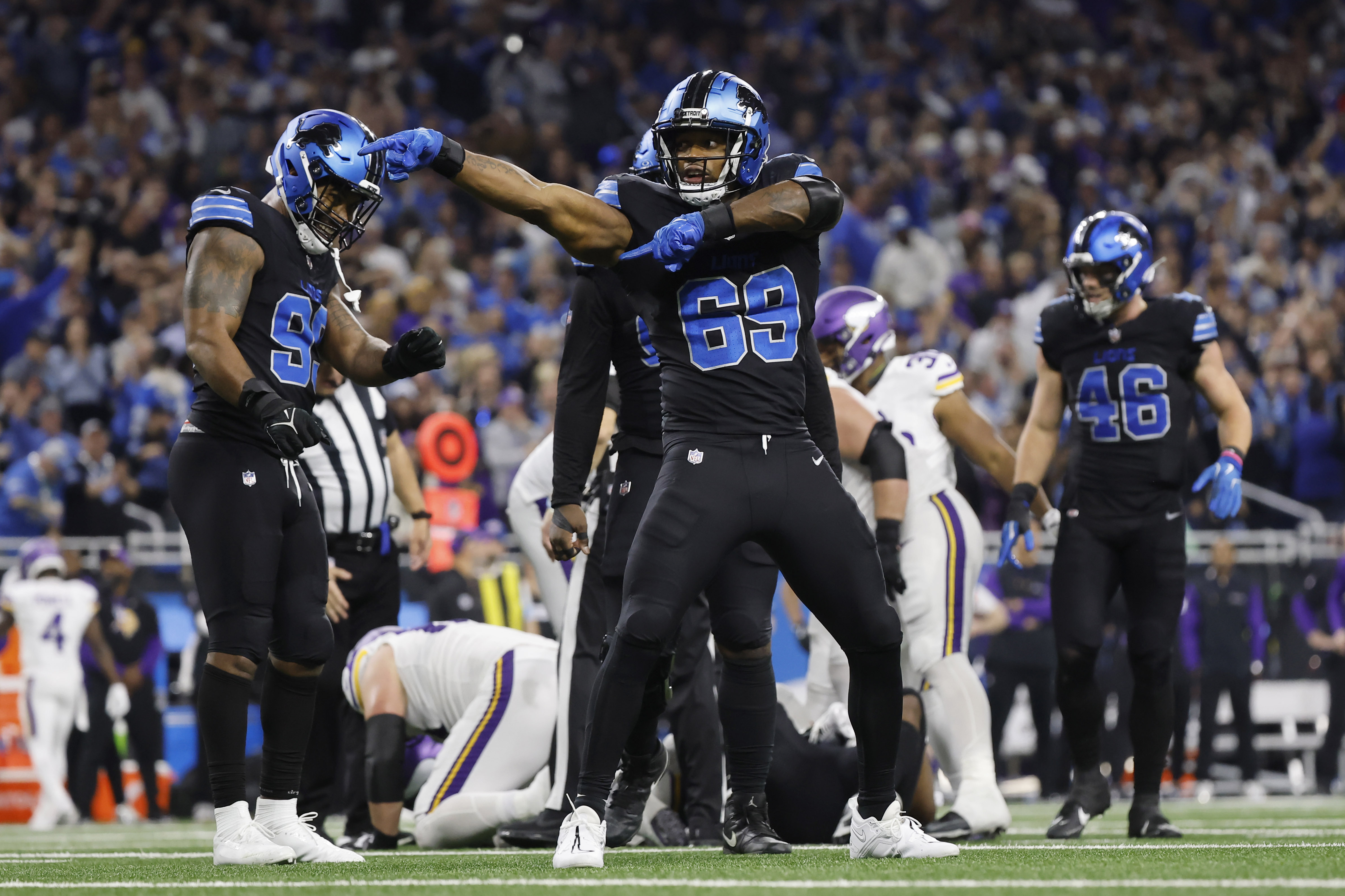 Detroit Lions linebacker Al-Quadin Muhammad (69) celebrates after helping to sack Minnesota Vikings quarterback Sam Darnold during the second half of an NFL football game Sunday, Jan. 5, 2025, in Detroit.