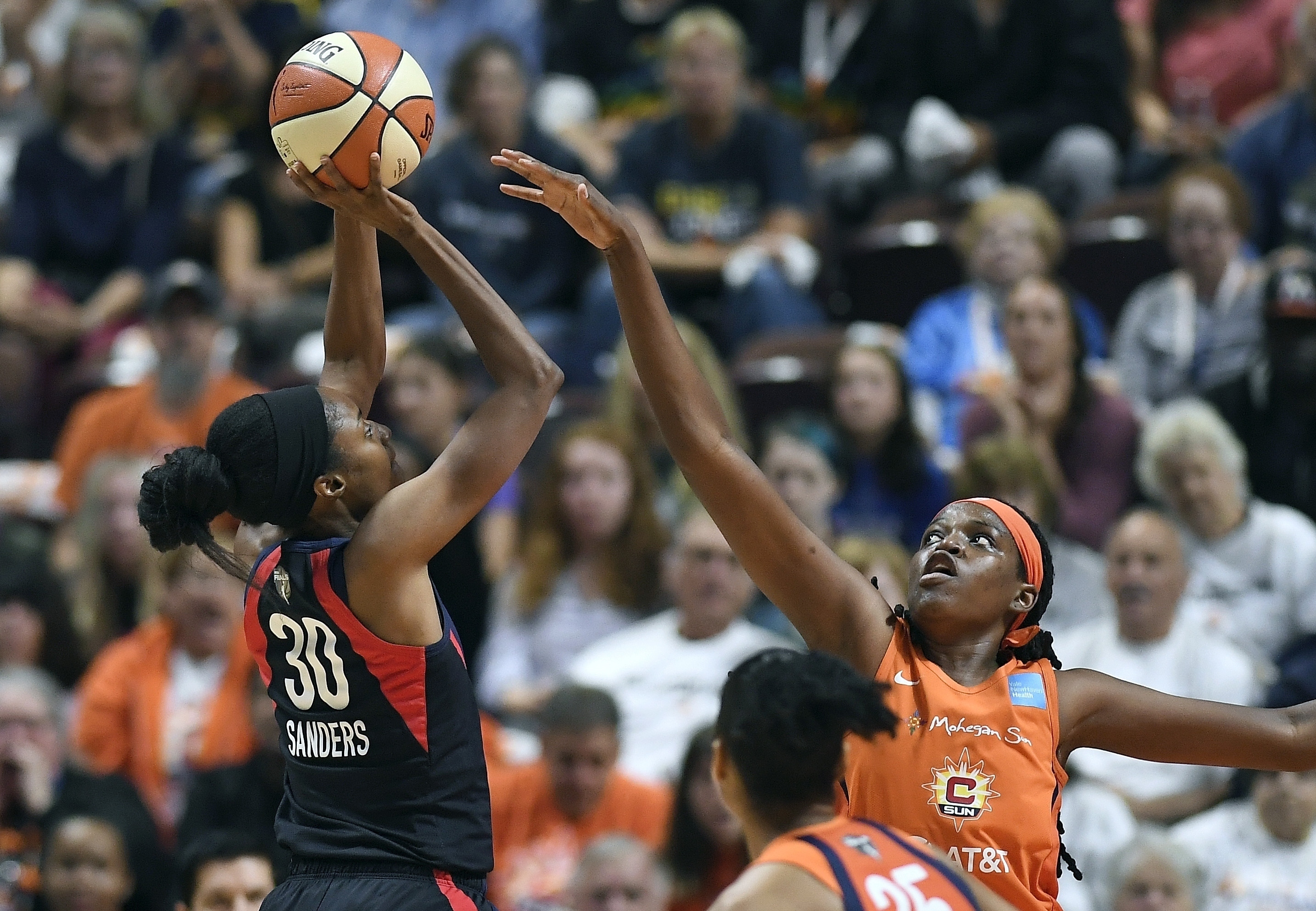 FILE - Washington Mystics' LaToya Sanders, left, shoots against Connecticut Sun's Jonquel Jones, right, during the first half in Game 3 of basketball's WNBA Finals, Oct. 6, 2019, in Uncasville, Conn.